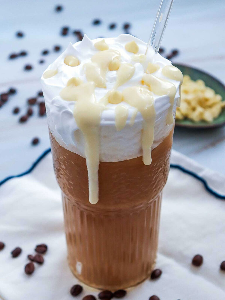 Iced white chocolate mocha in a tall glass.