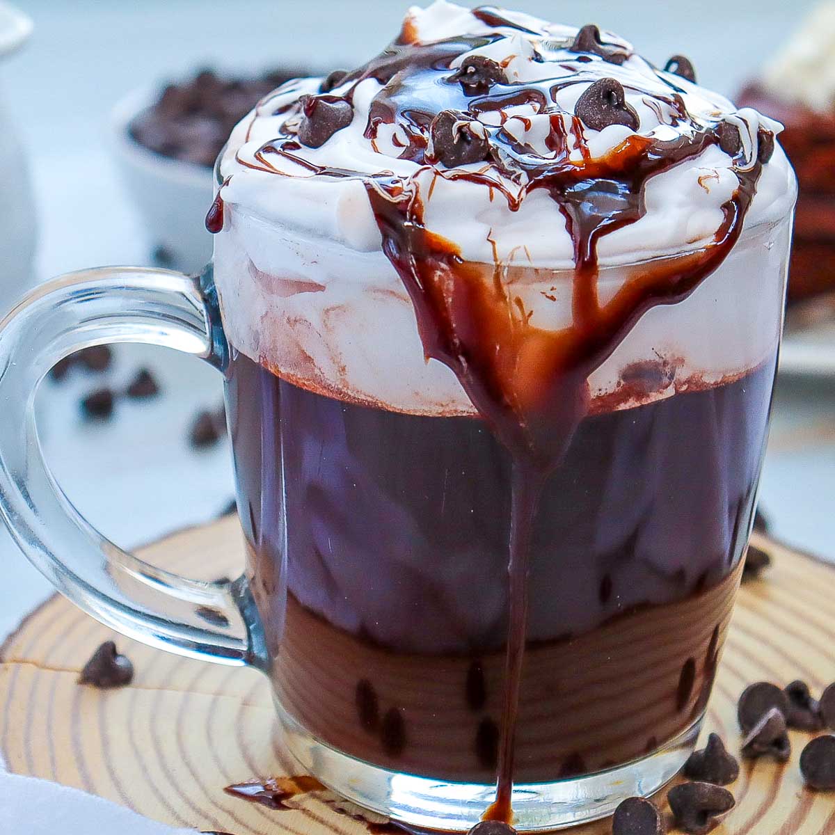 Close up of mocha hot chocolate topped with cream and chocolate chips.