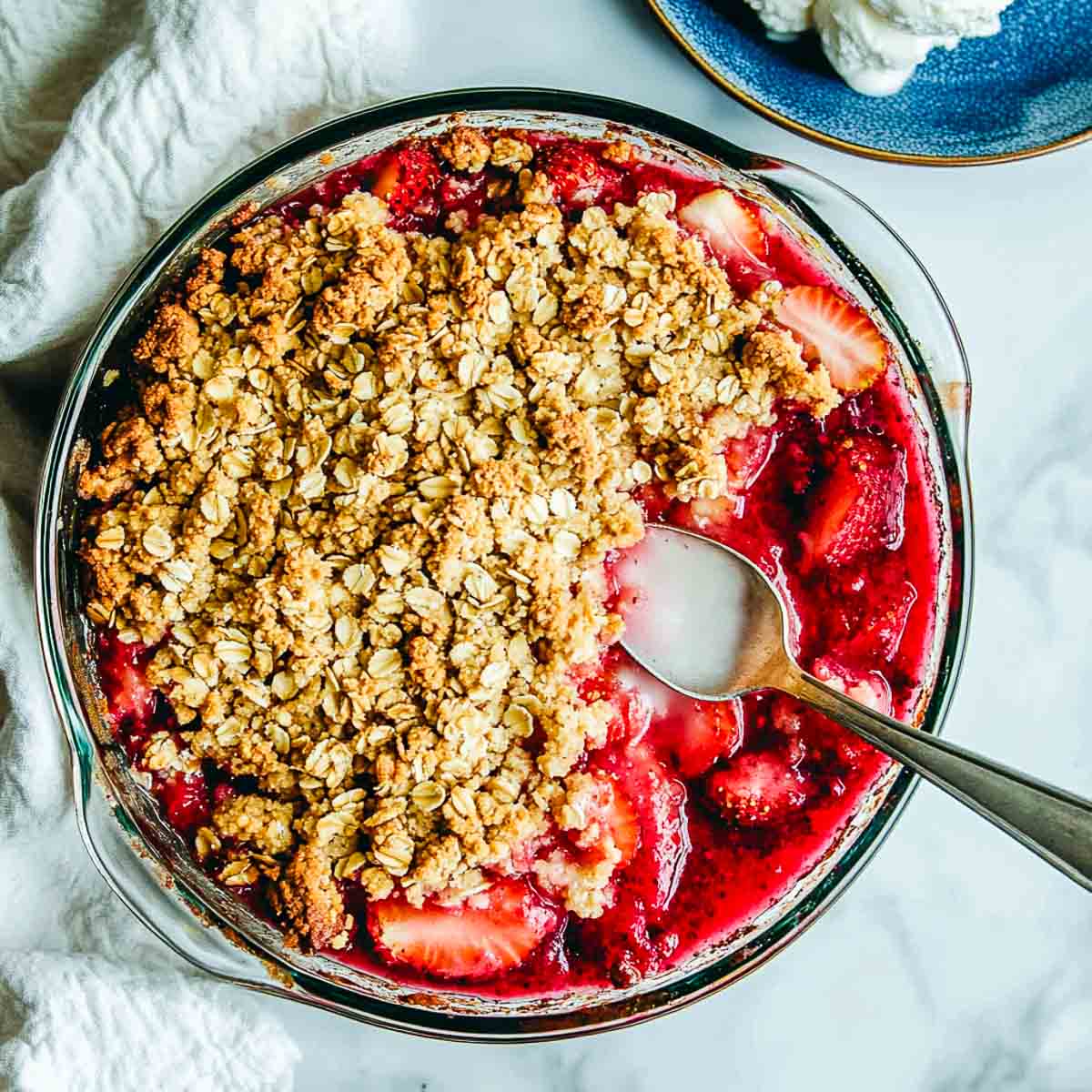 A bowl of strawberry rhubarb crisp in a bowl.
