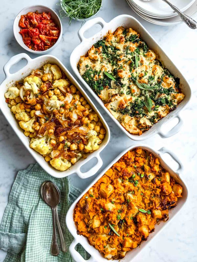 Three casseroles placed on a white marble surface.