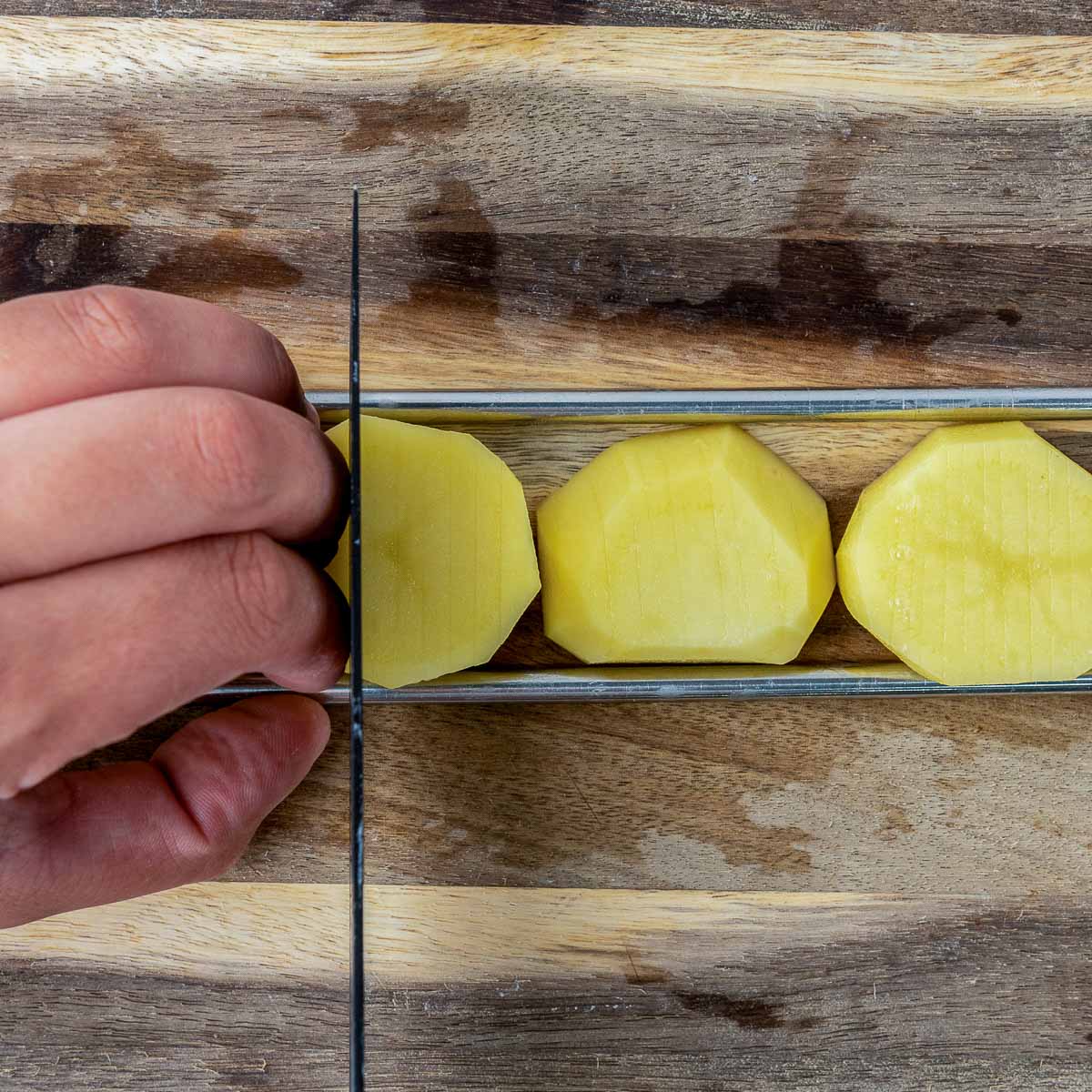 Slices placed on chopsticks and cut vertically.