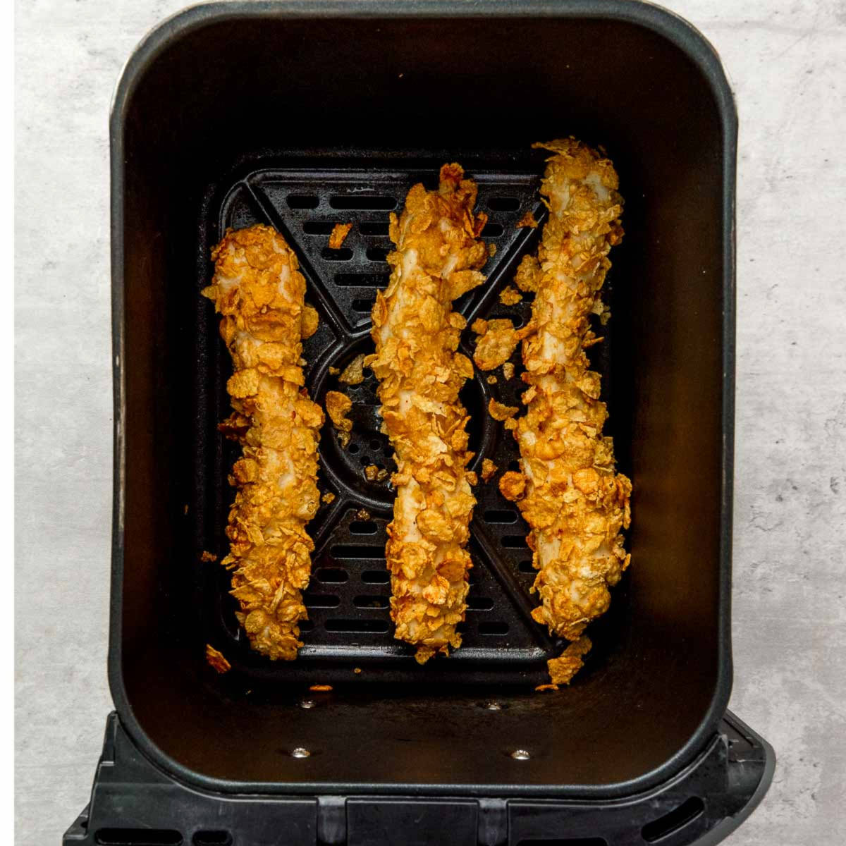 Chicken air fried until crispy in the air fryer basket.