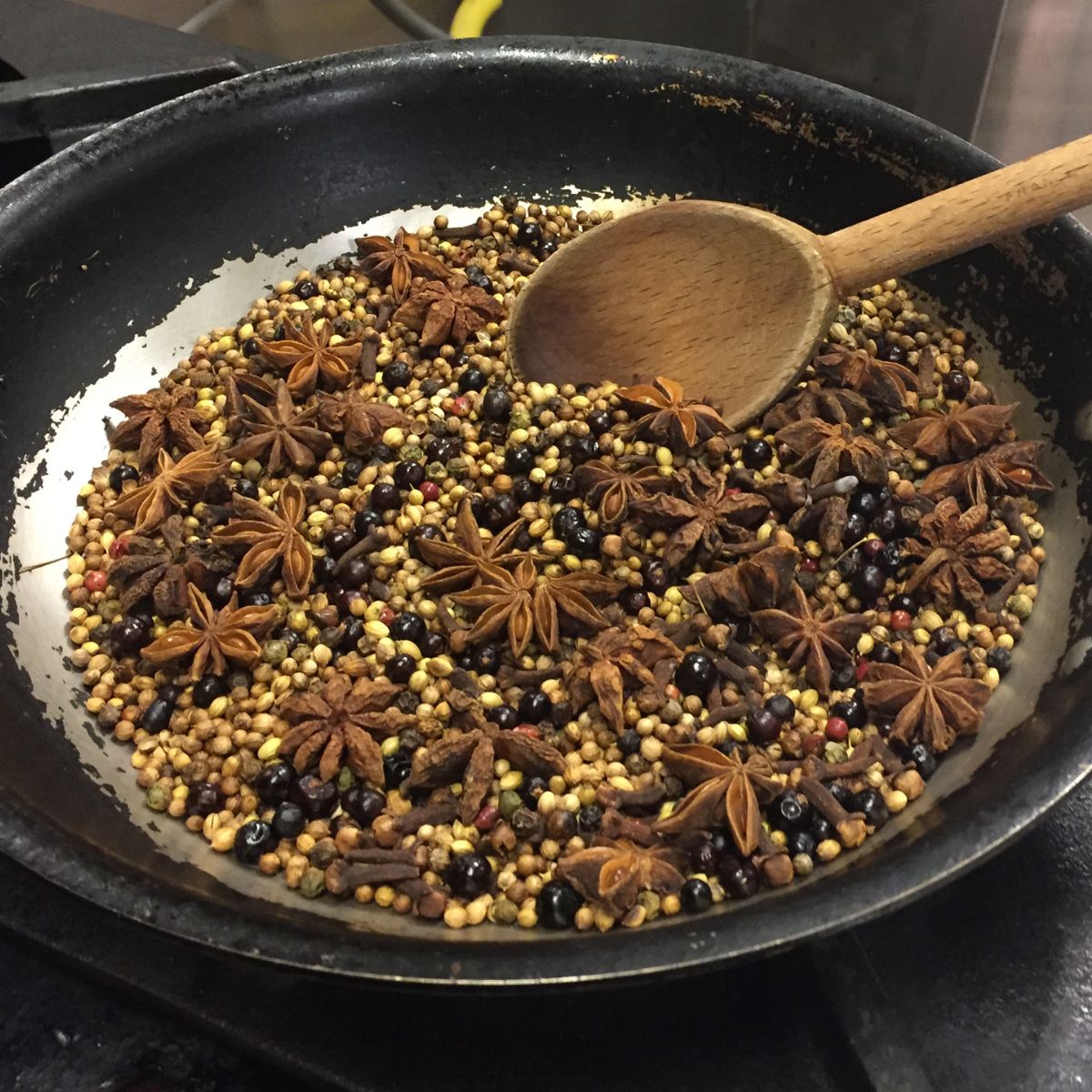 Spices being toasted in a cast iron pan.