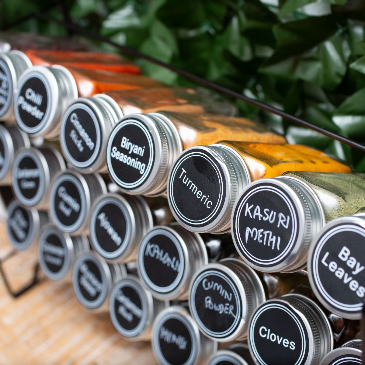 Glass bottles filled with different types of spices.