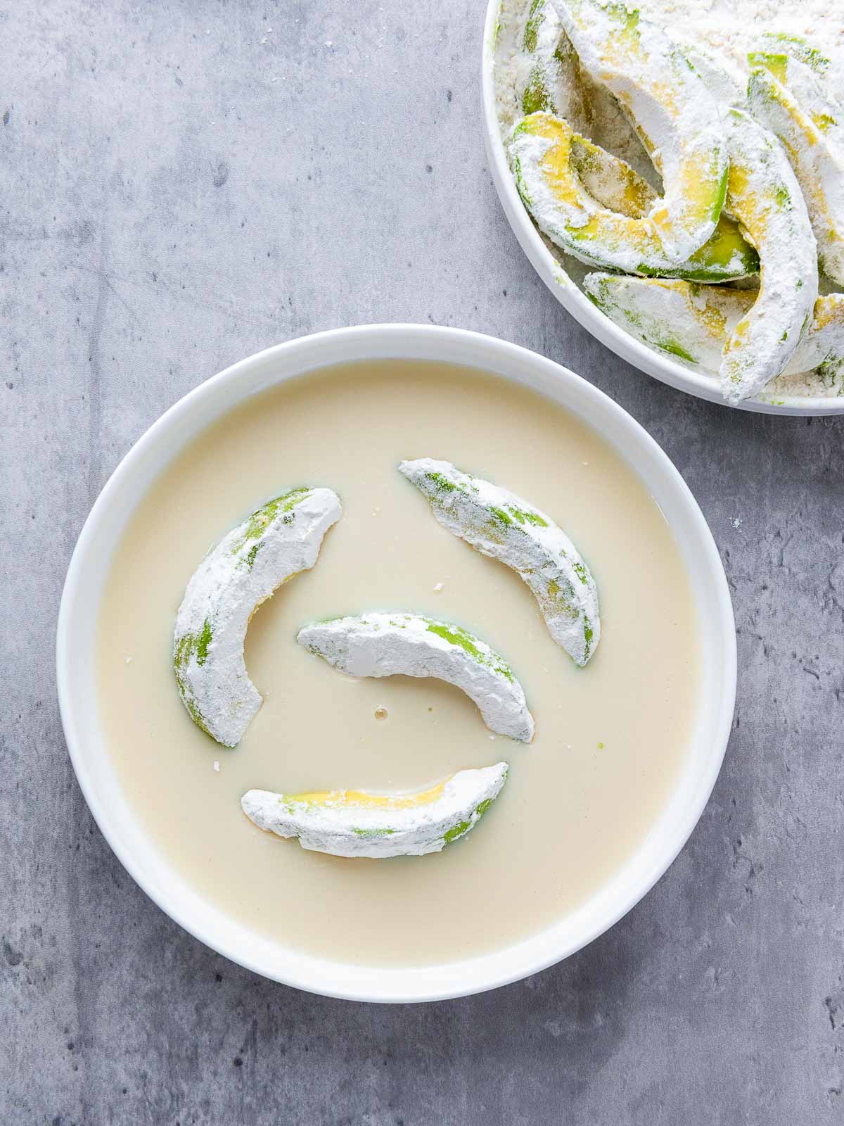 Avo slices dreached in flour and dipped in soy milk.