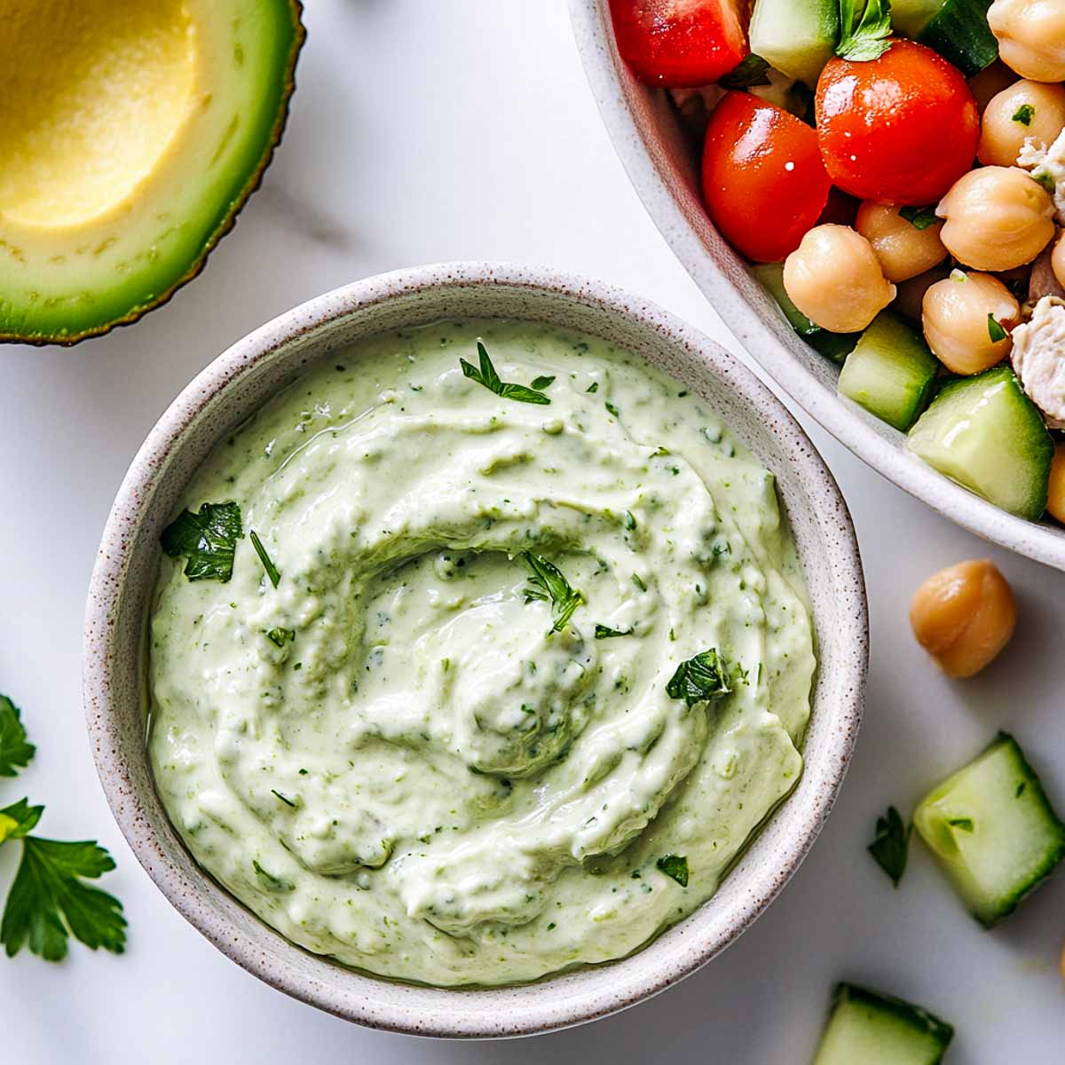 Avocado Greek yogurt dressing with tuna chickpea salad and fresh parsley.
