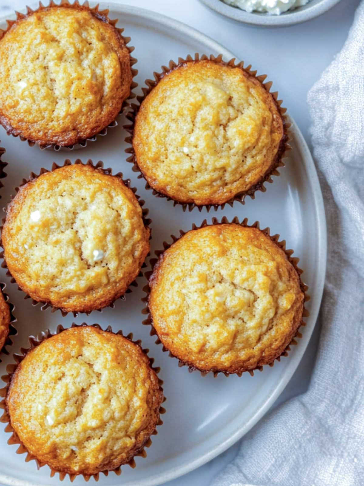 Close up of banana cottage cheese muffins on a white plate.