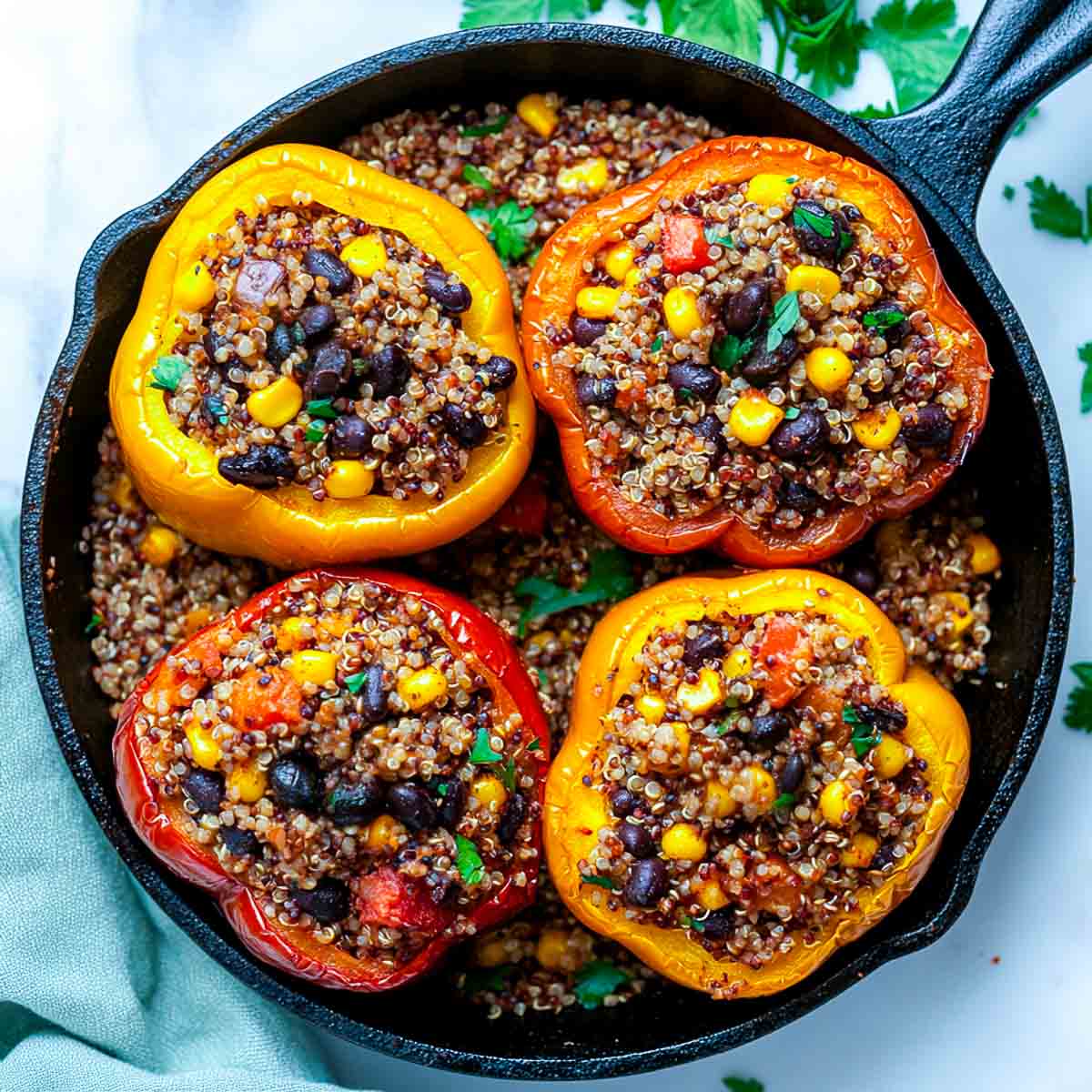 Black bean and quinoa stuffed peppers in a cast iron skillet.