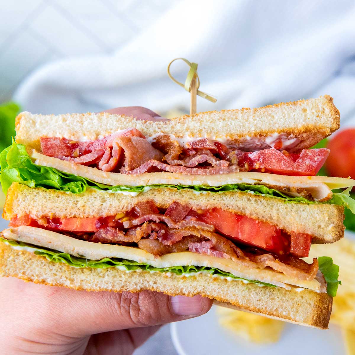 Close up of chicken club sandwich showing the layers.