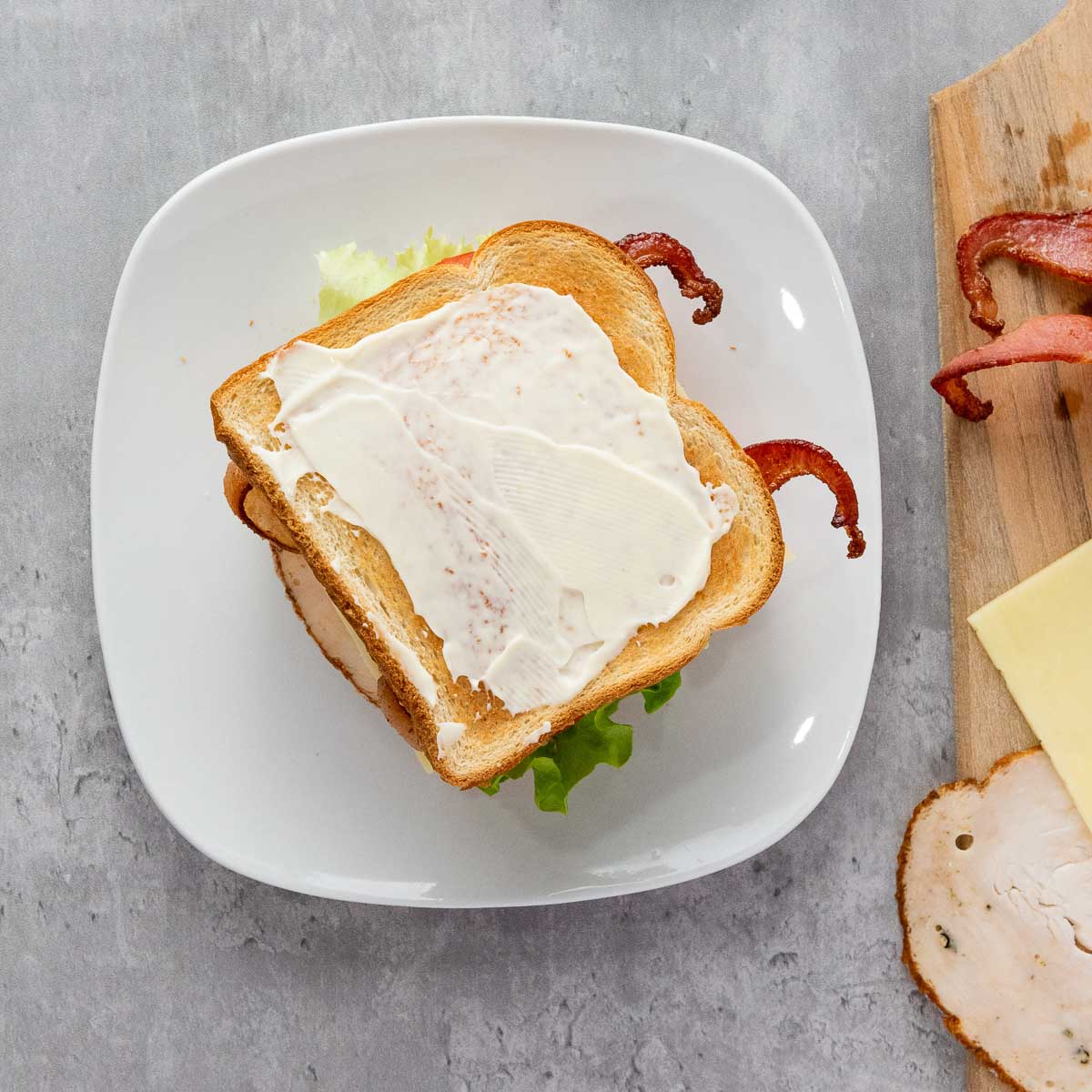 Second layer of bread and mayonnaise place on the top.