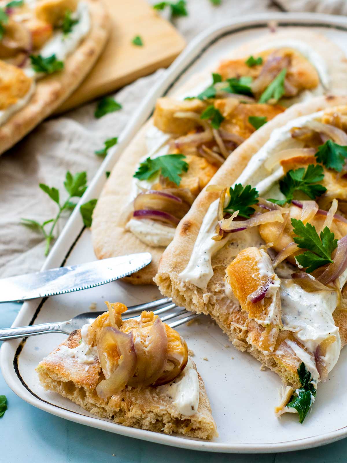 Close up of a slice of chicken pita on a serving plate.
