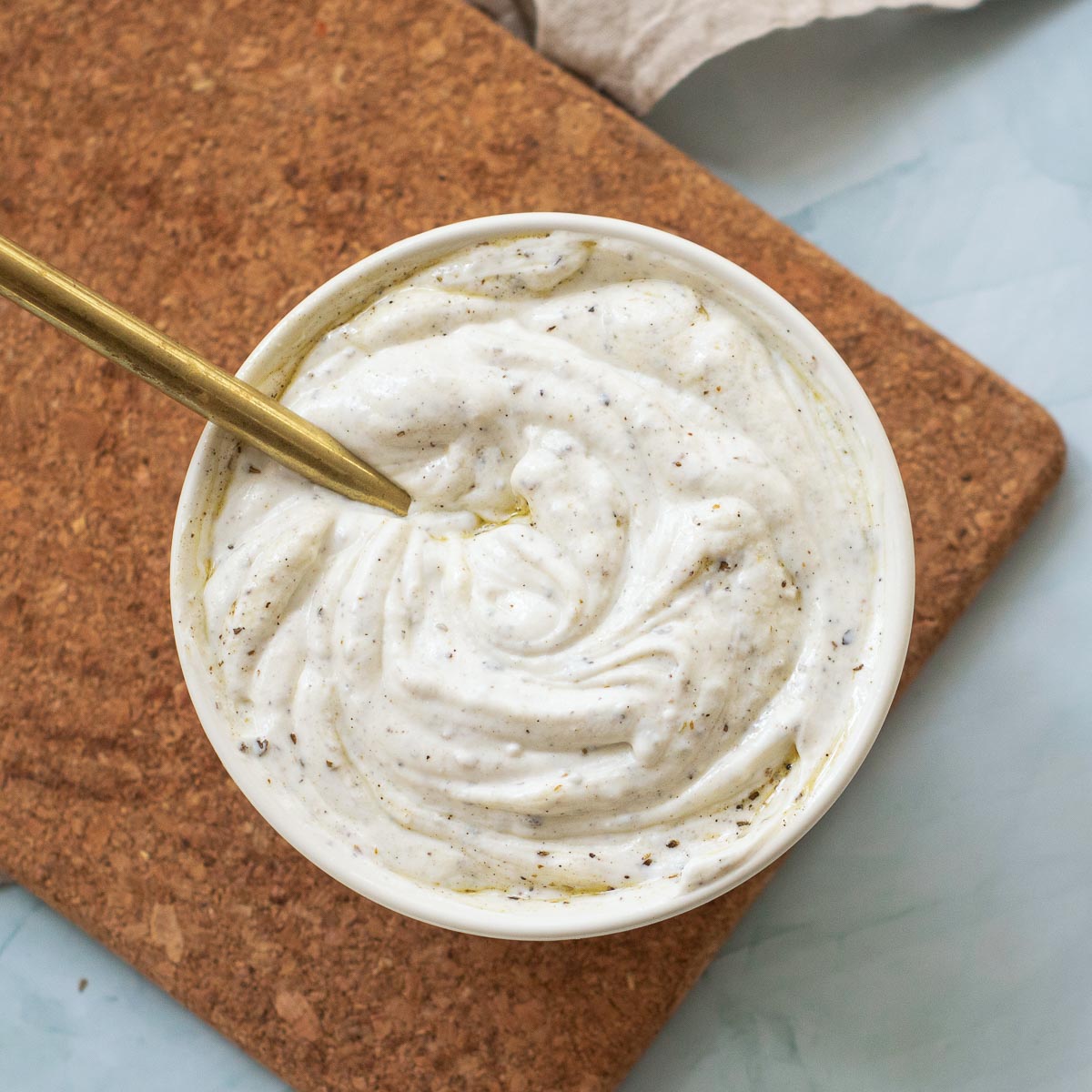 Yogurt sauce mixed in a small mixing bowl.