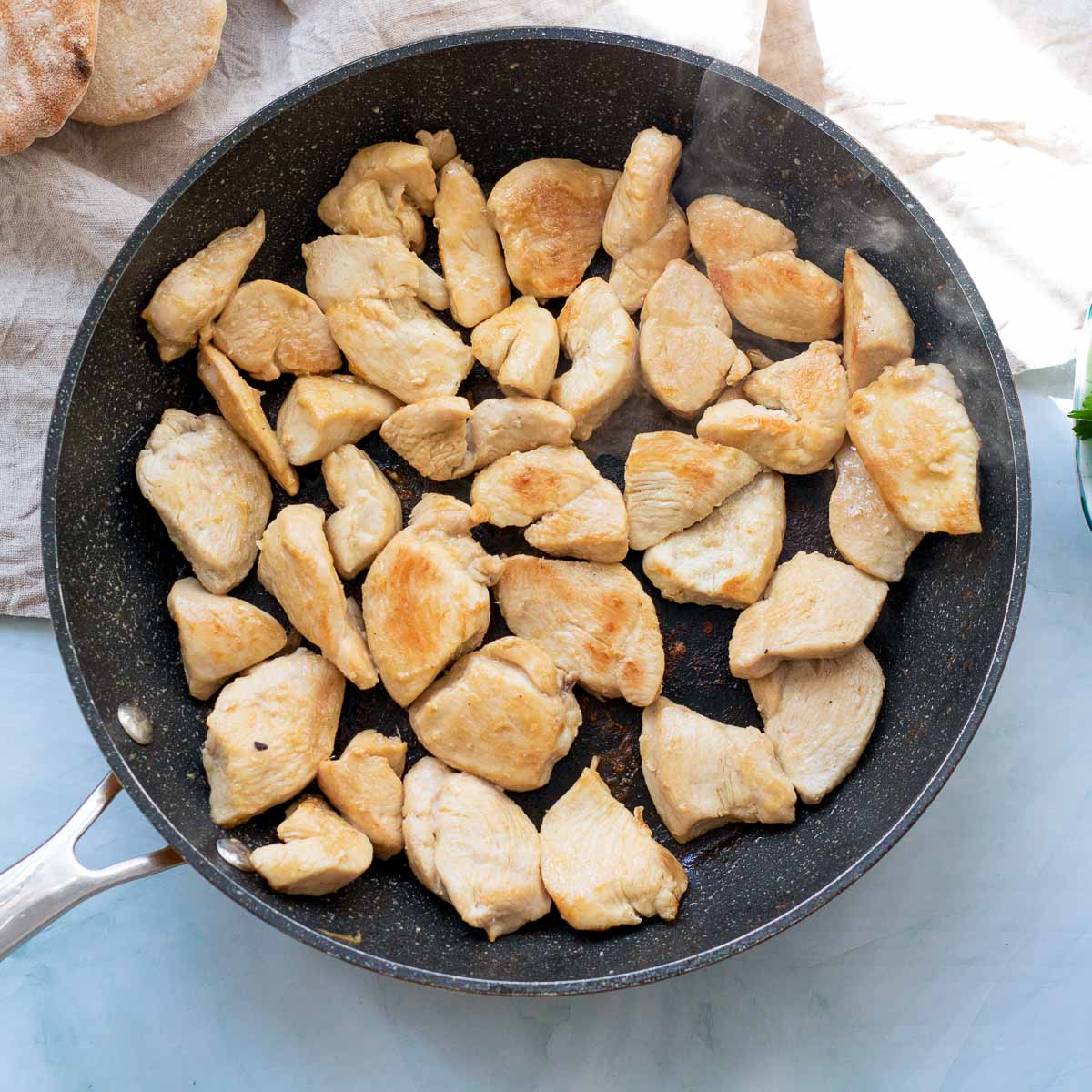 Cooked chicken breast in a skillet.