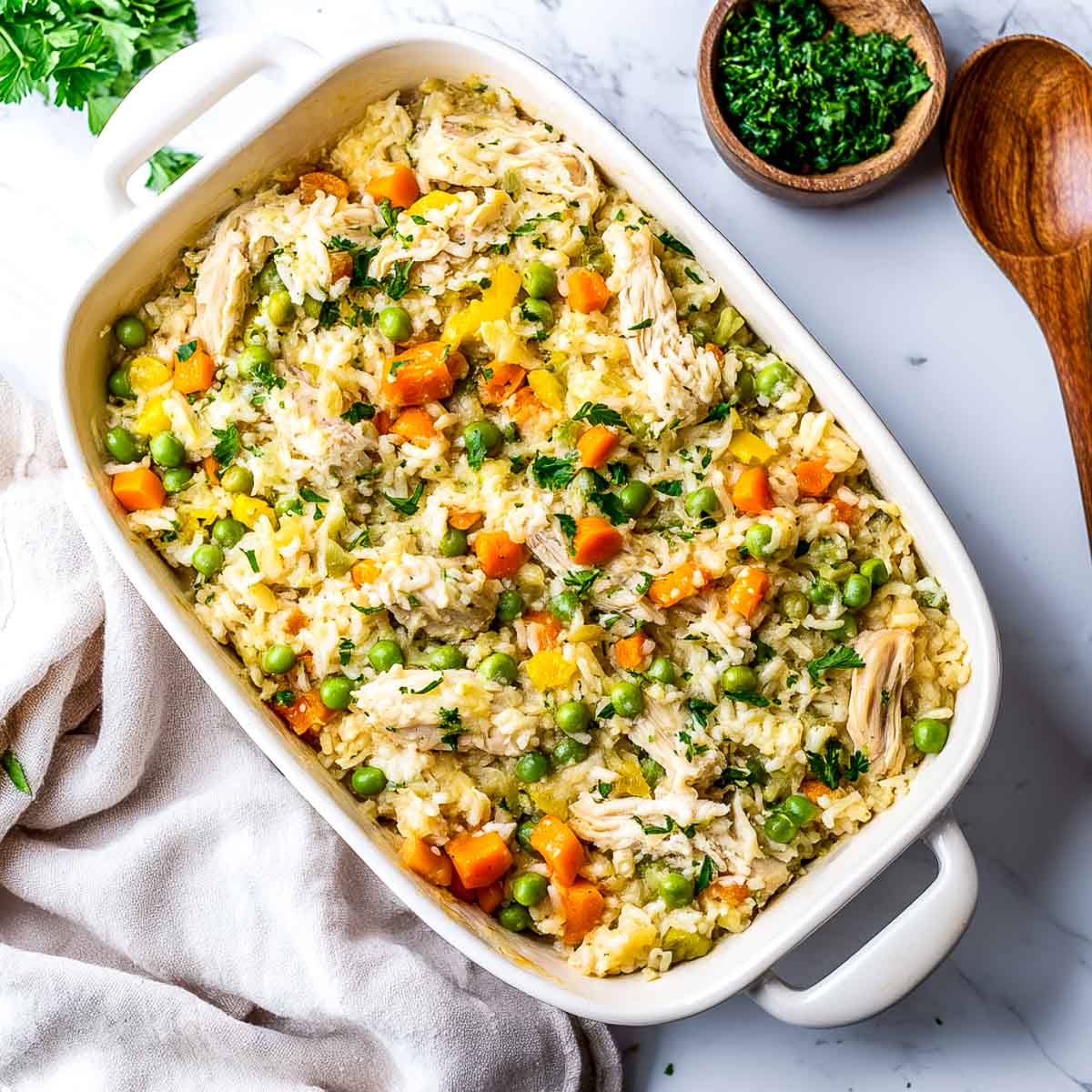 Chicken and rice casserole on a white marble surface.