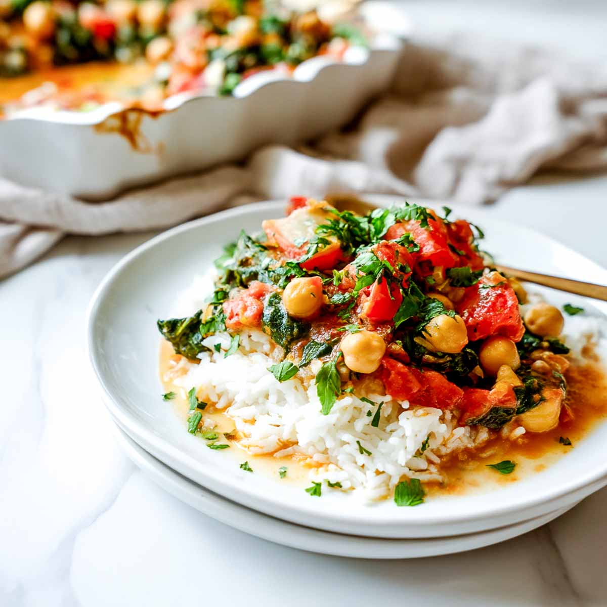 Chickpea and spinach casserole served over rice with tomato broth and herbs.