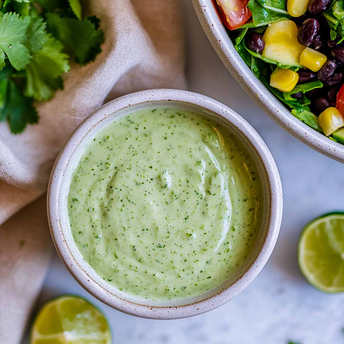 Cilantro lime Greek yogurt dressing with Mexican chopped salad and lime wedges.