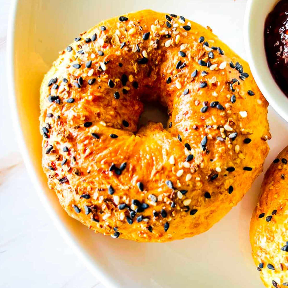 Close up of cottage cheese bagels on a white plate.