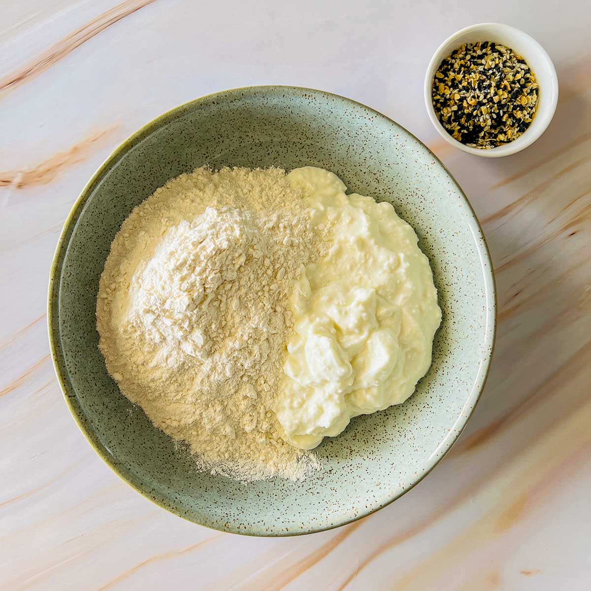 Blended cottage cheese and flour in a wide bowl.