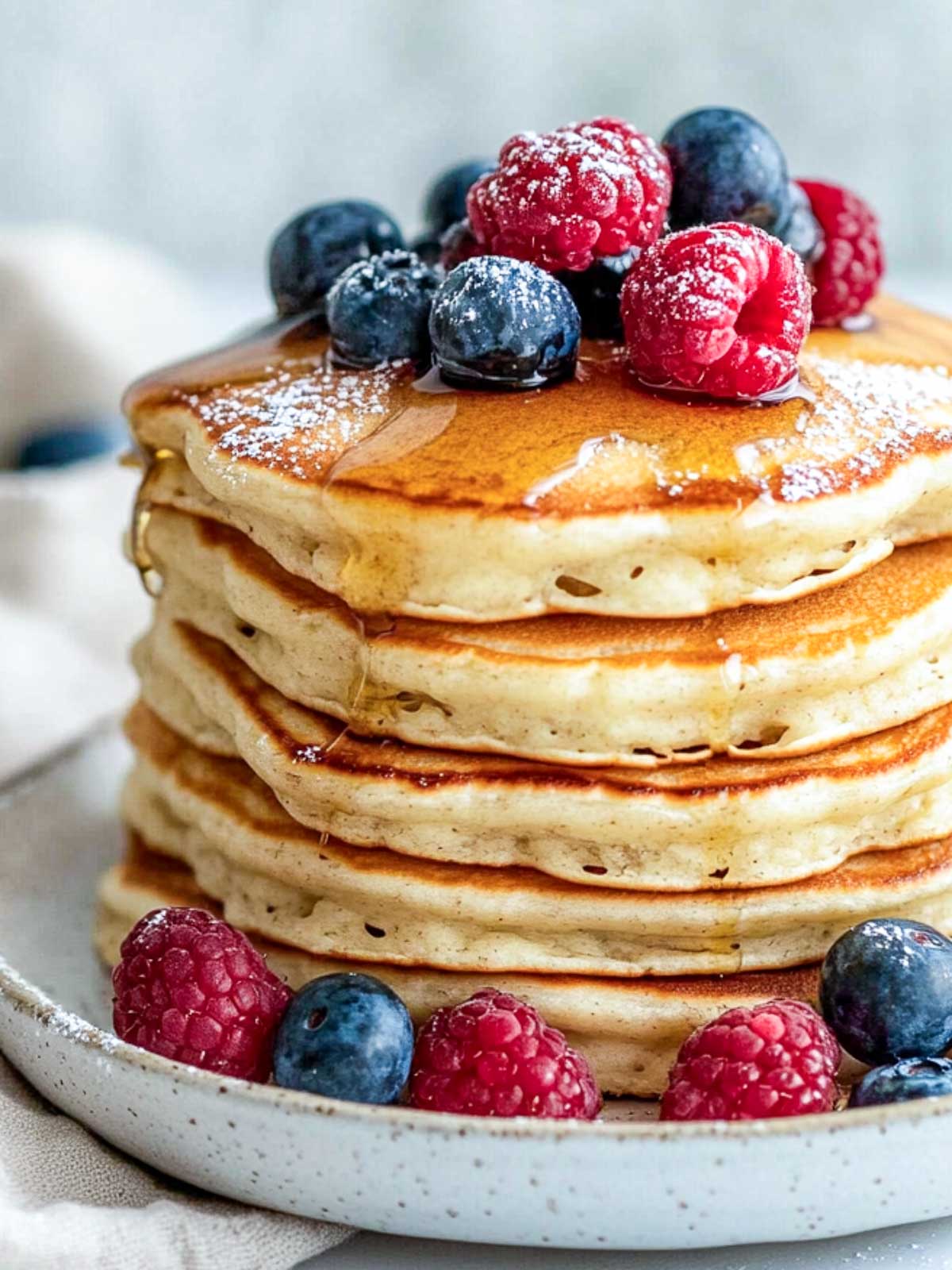 Close up of a stack of cottage cheese pancakes.