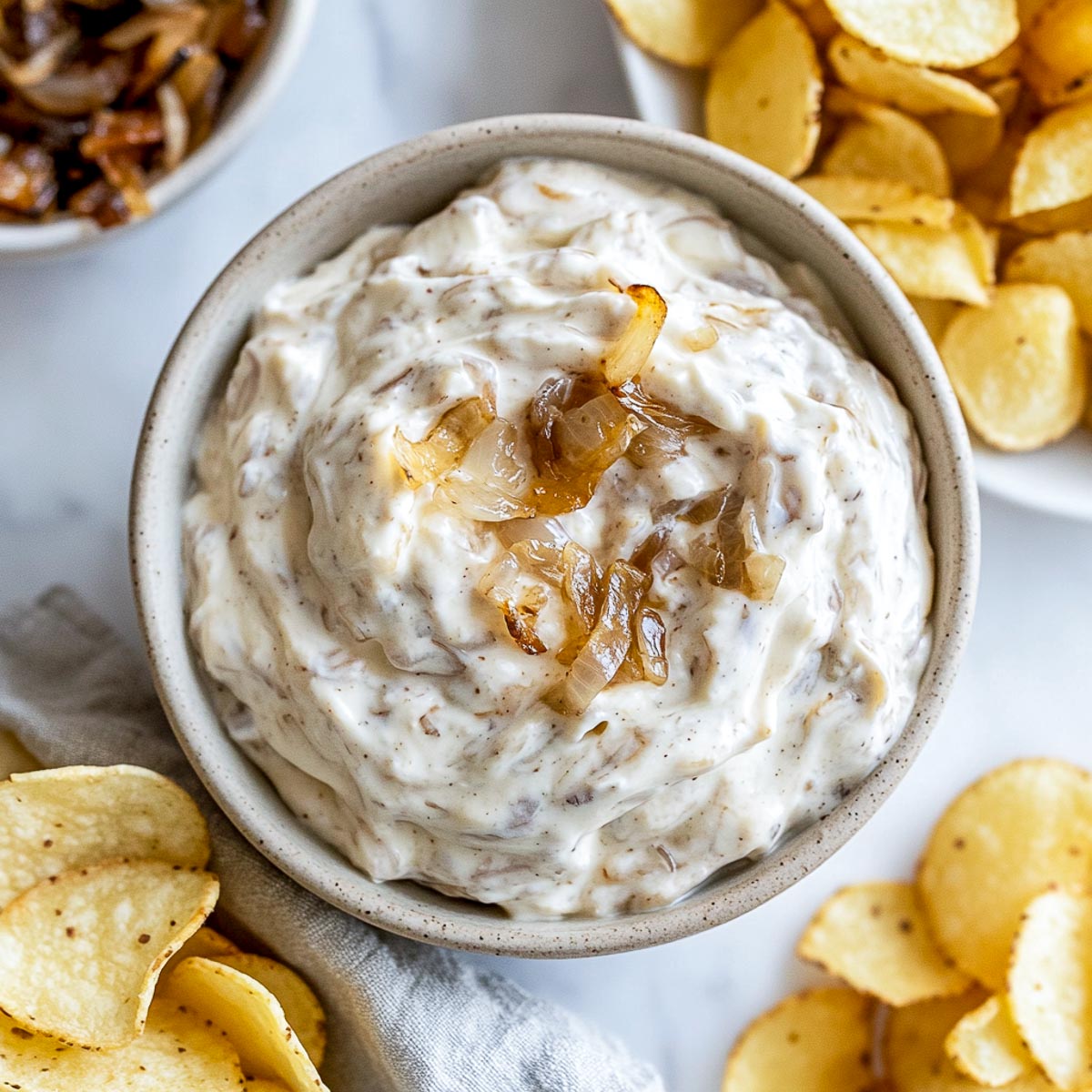 French onion Greek yogurt dip with caramelized onions and potato chips.