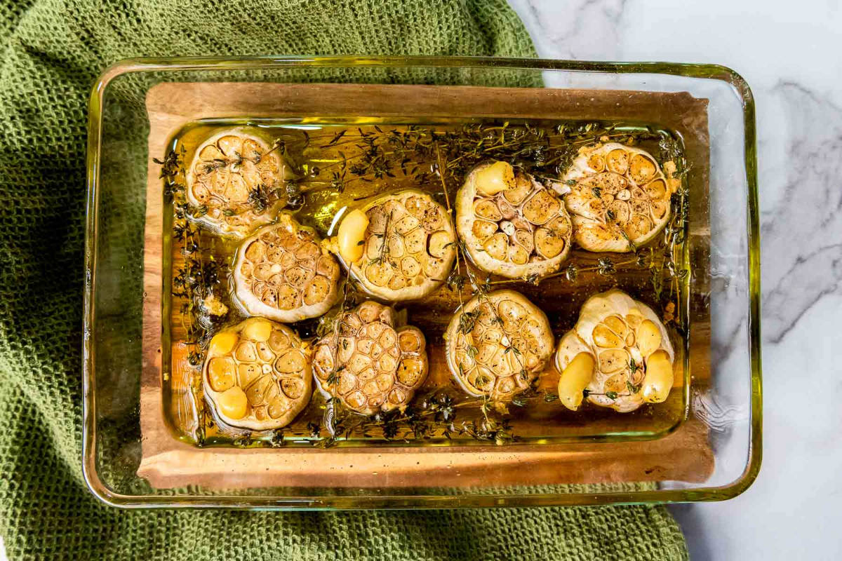 Baking dish cooling on a wooden board after baking.