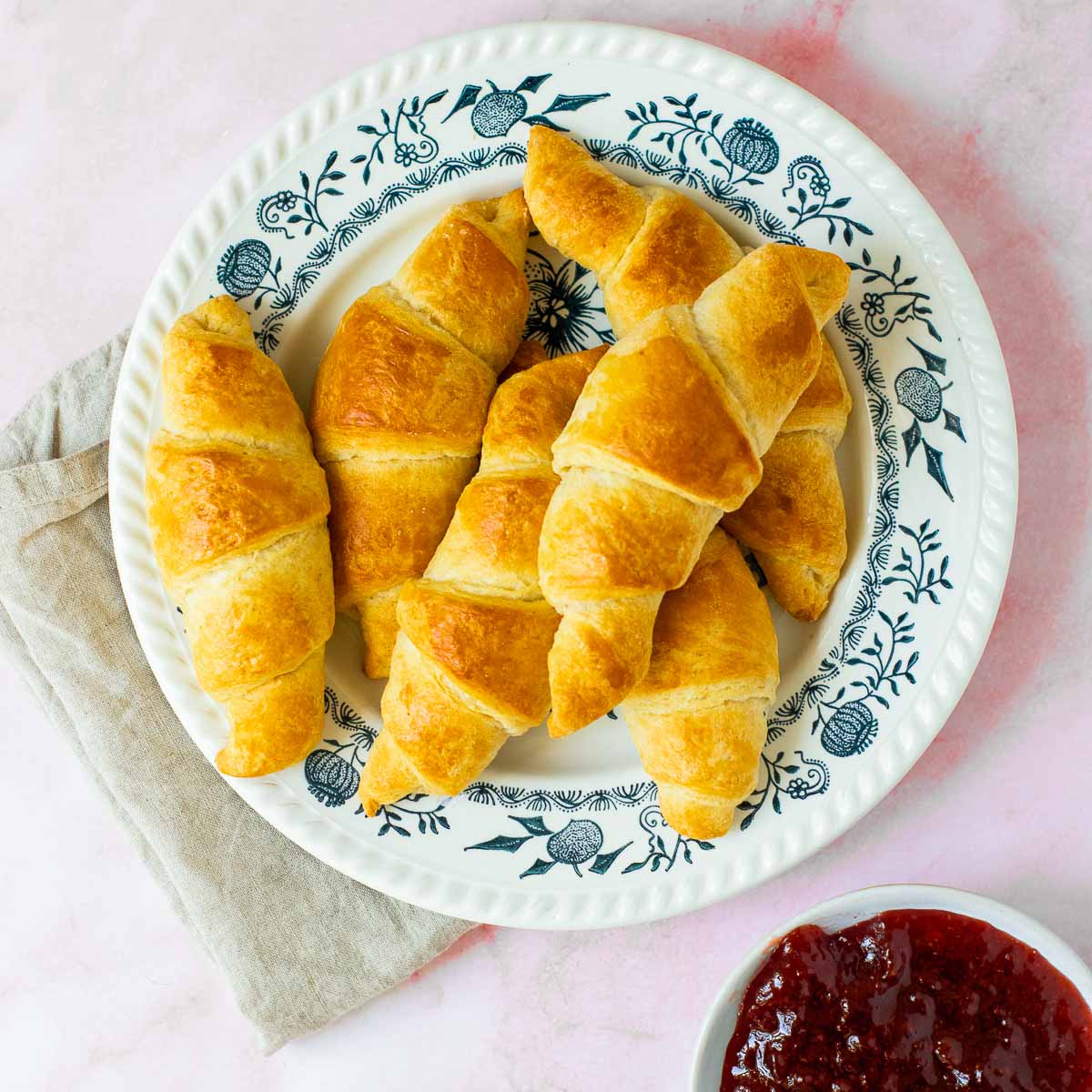Top view of croissants placed on a white plate.