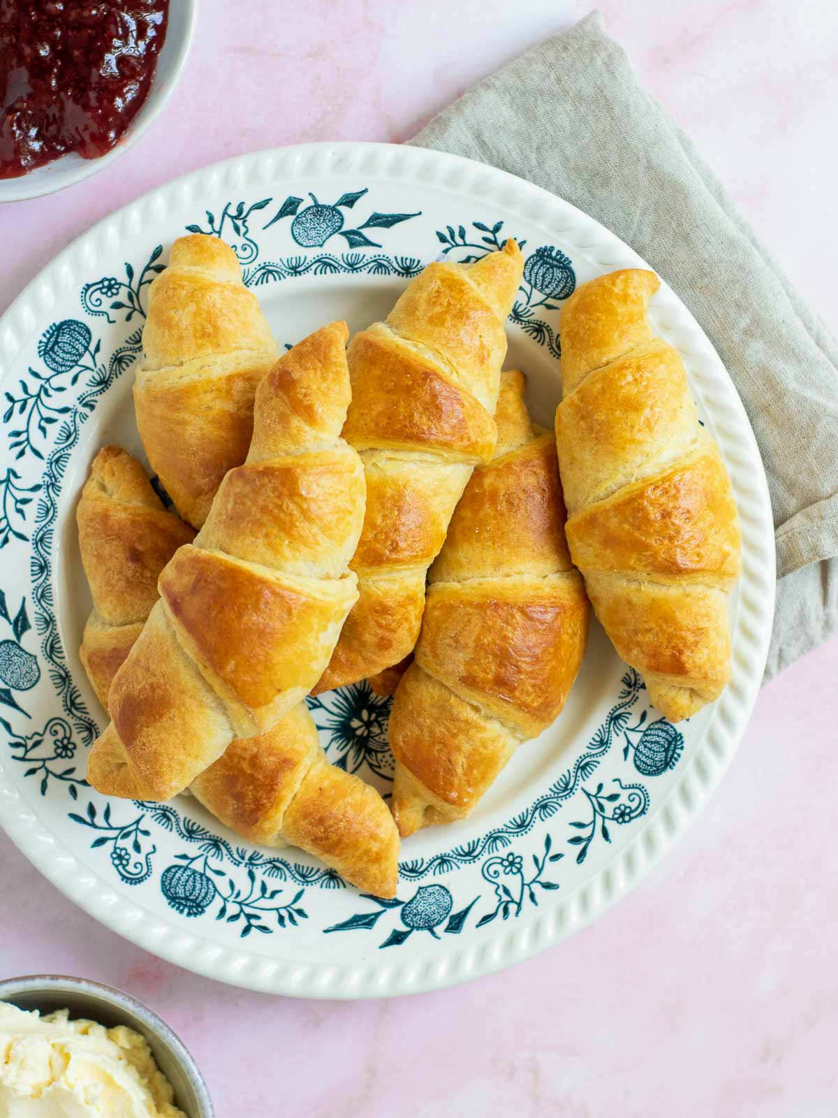 Homemade croissants served with jam and butter.