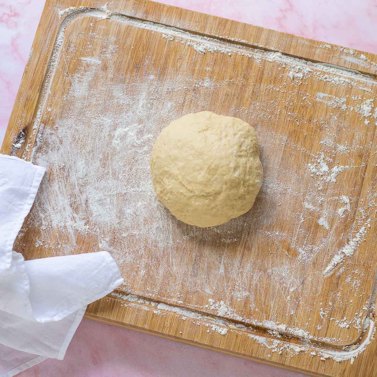 Dough after kneading on a wooden board.