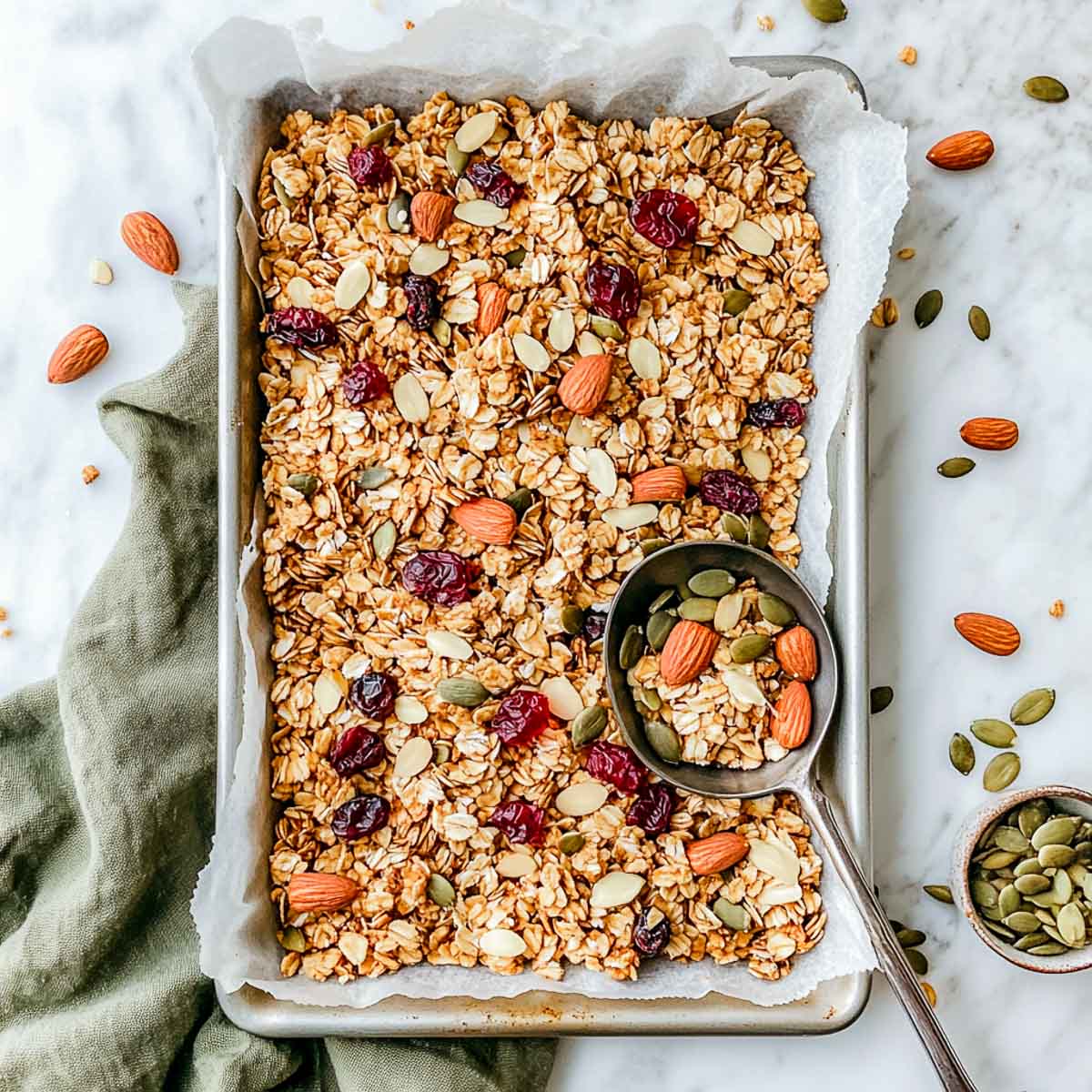 Top-down granola in tray with nuts, seeds, and no added sugar.