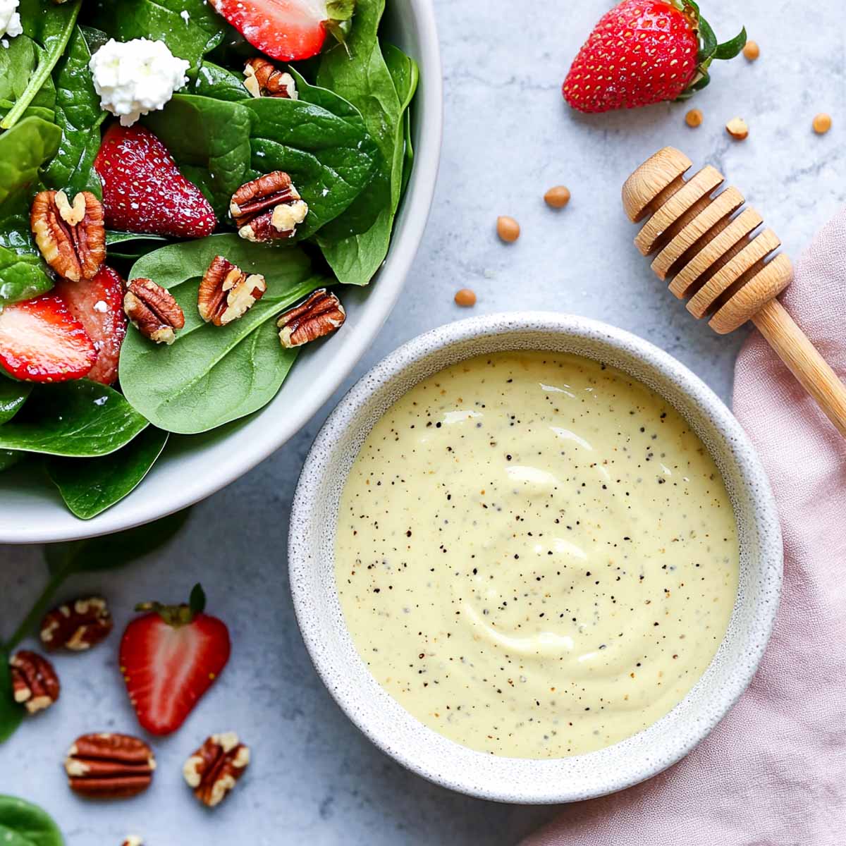 Honey mustard Greek yogurt dressing with spinach strawberry salad and pecans.