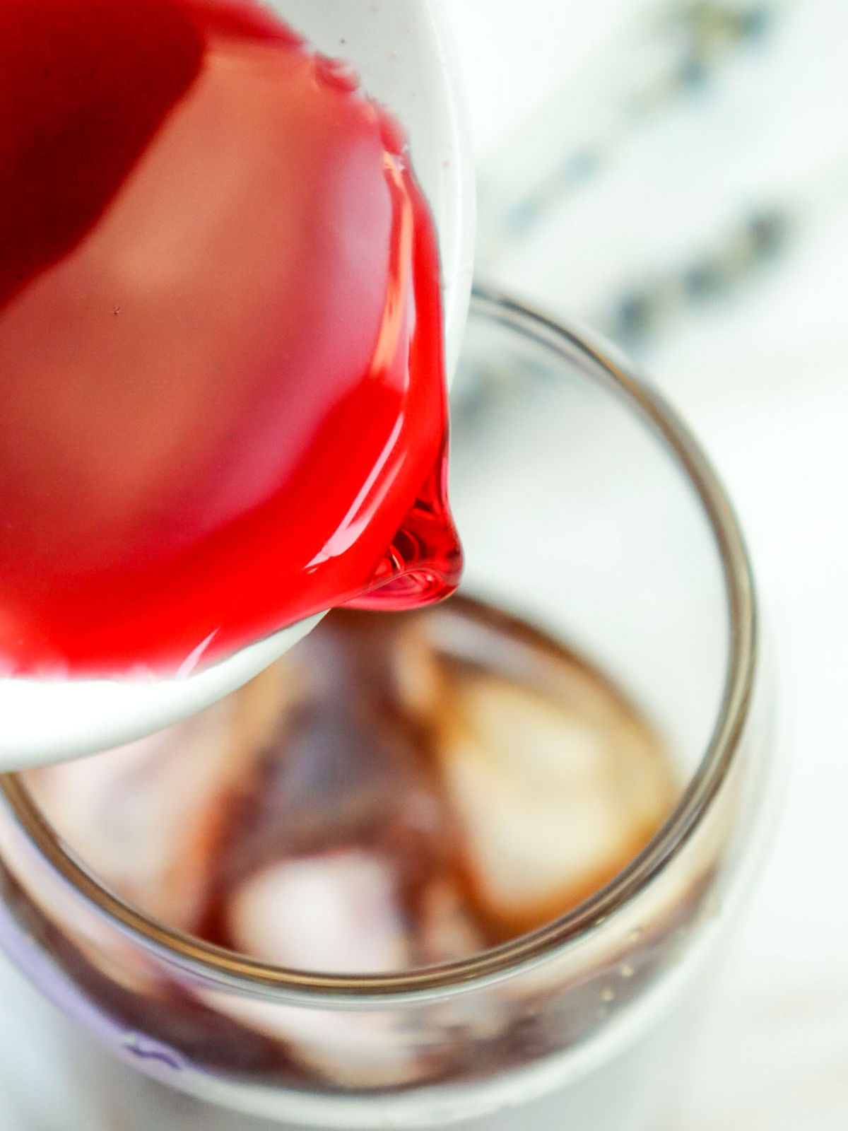 Lavender syrup being poured into the glass.
