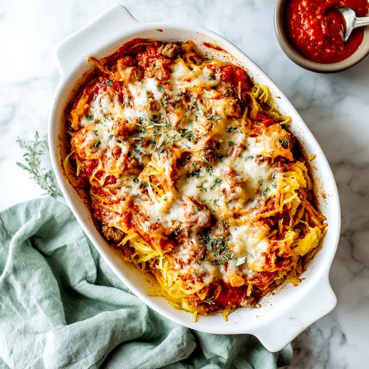 Baked spaghetti squash casserole with tomato sauce and melted cheese on top.