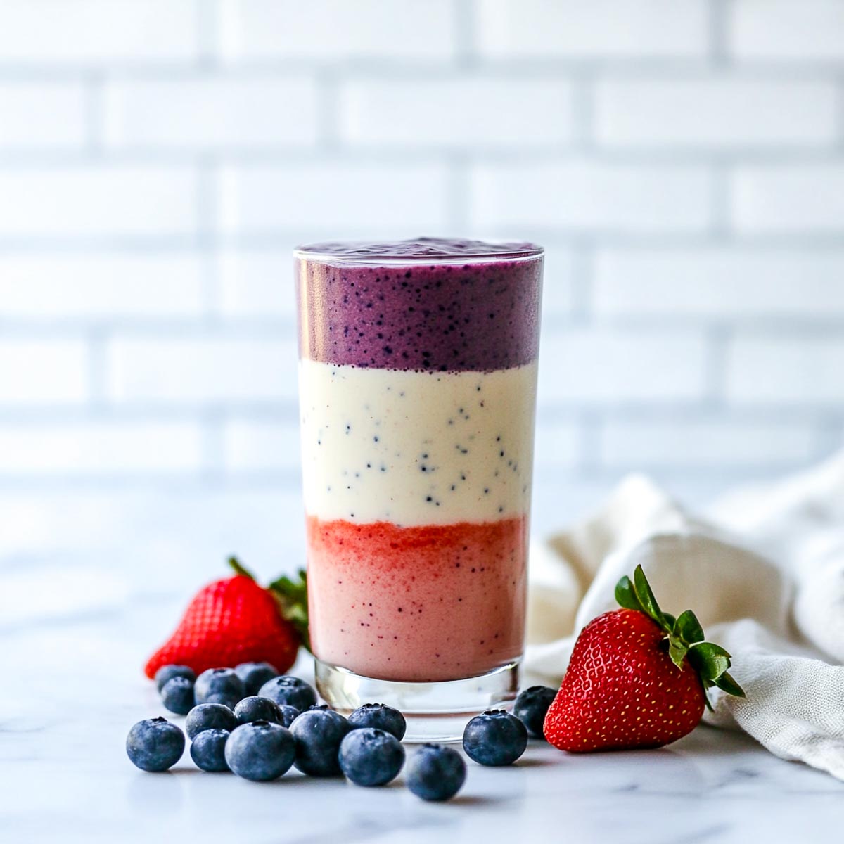 Smoothie with three layers of red, white, and blue colors.