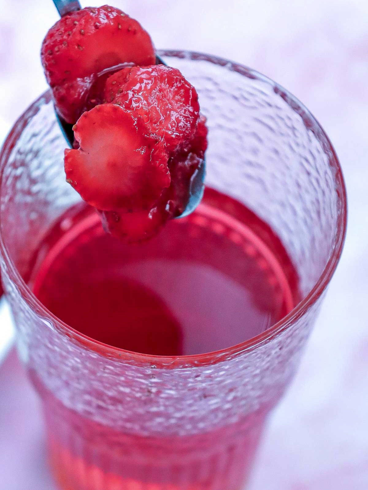 Frozen strawberries poured into the glass.