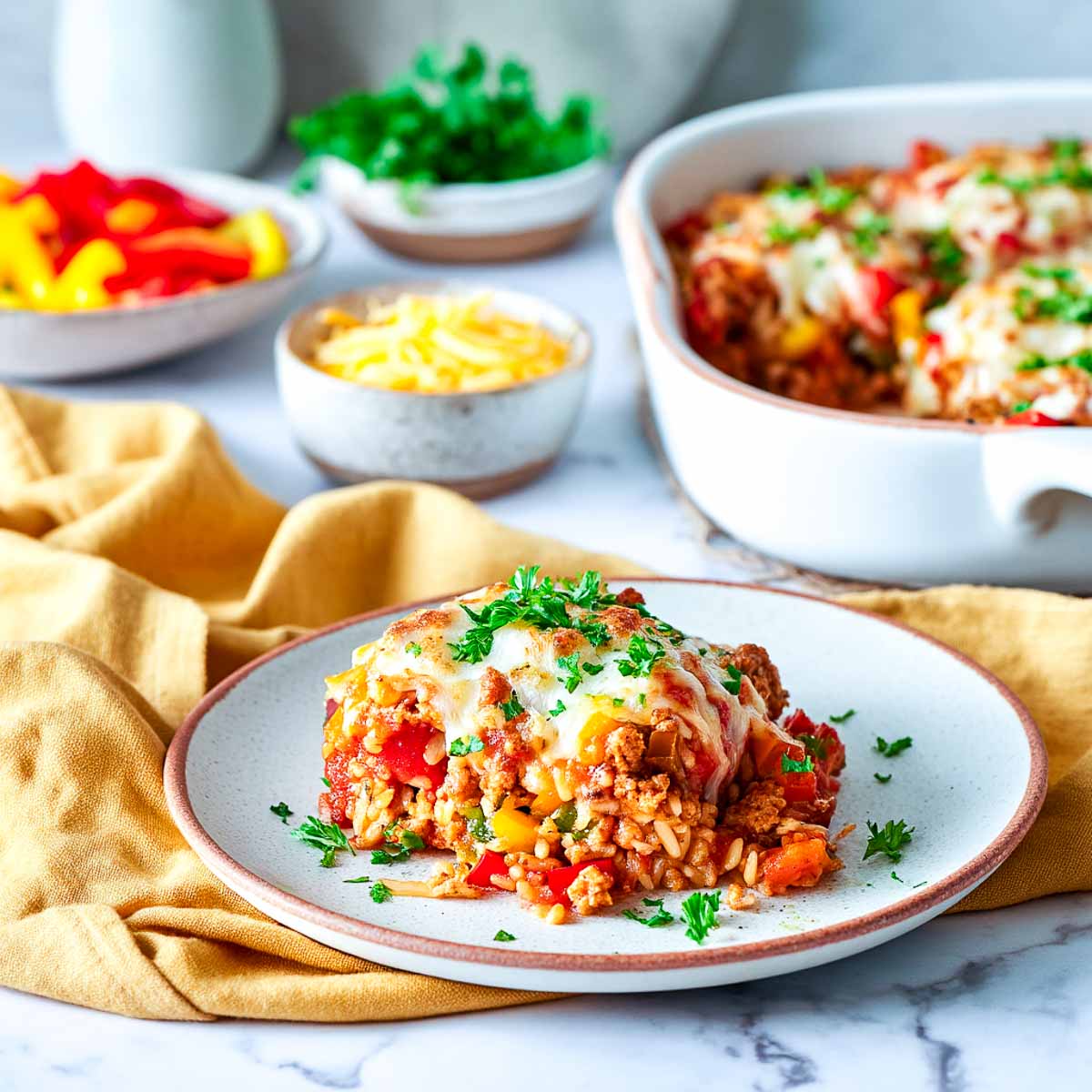 Cheesy stuffed bell pepper casserole with brown rice and turkey served on a plate.