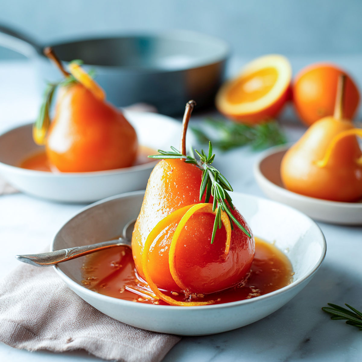 Aperol poached pear in a white bowl with syrup, rosemary, and orange zest.