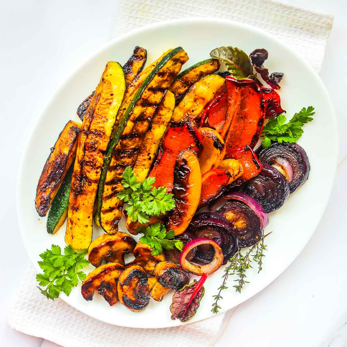 Balsamic grilled vegetables served on a white plate.