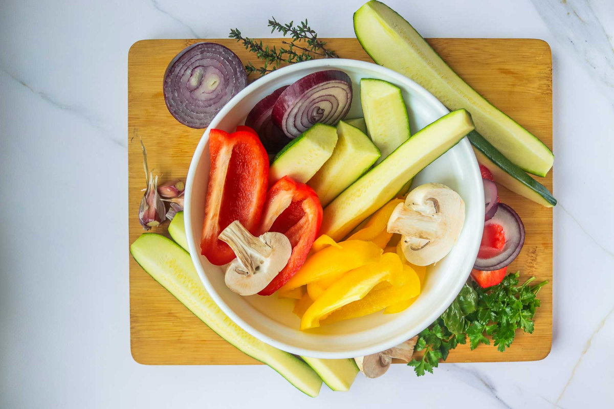 Vegetables cut and placed on a wooden board.