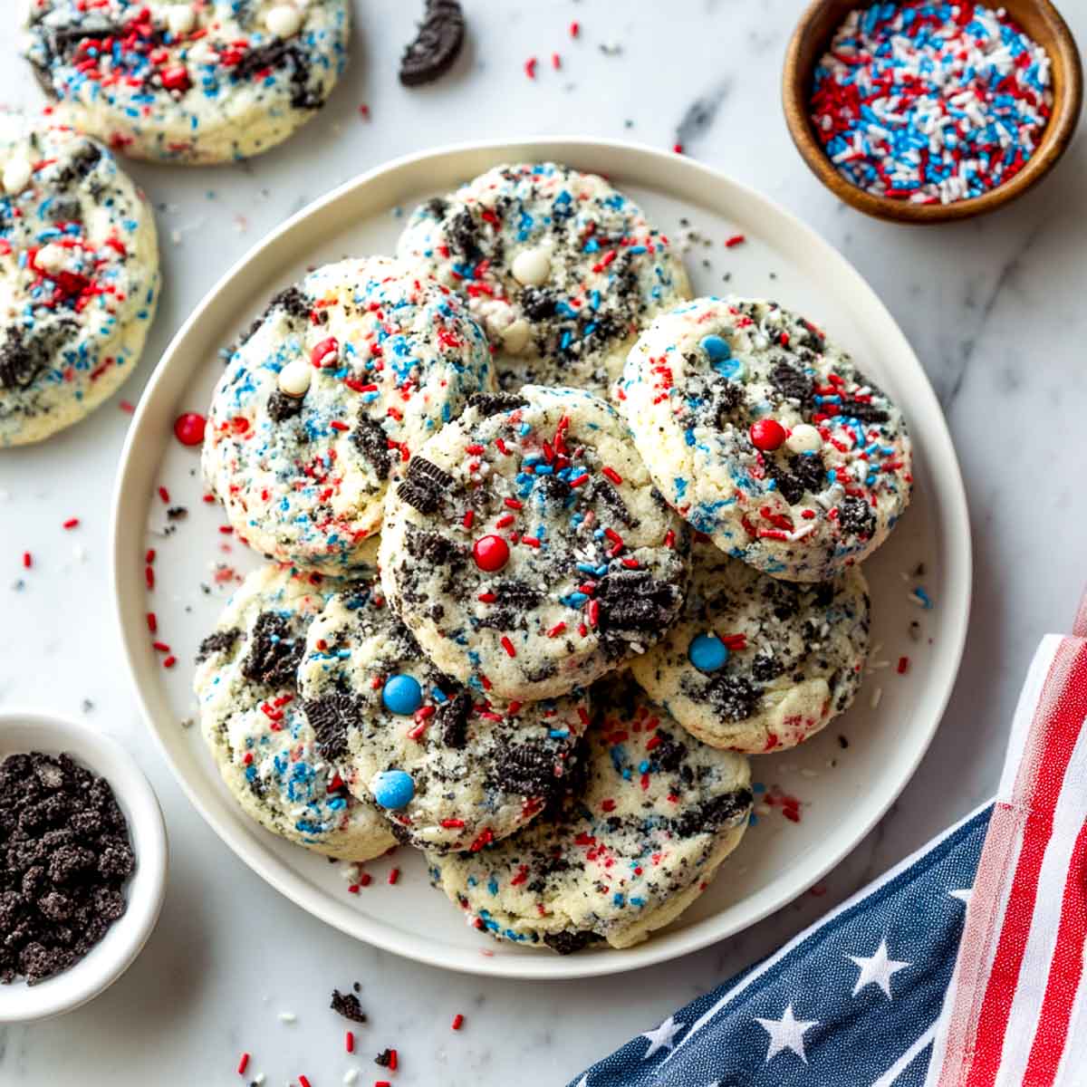 Top-down view of Oreo-loaded cookies with red, white, and blue sprinkles.
