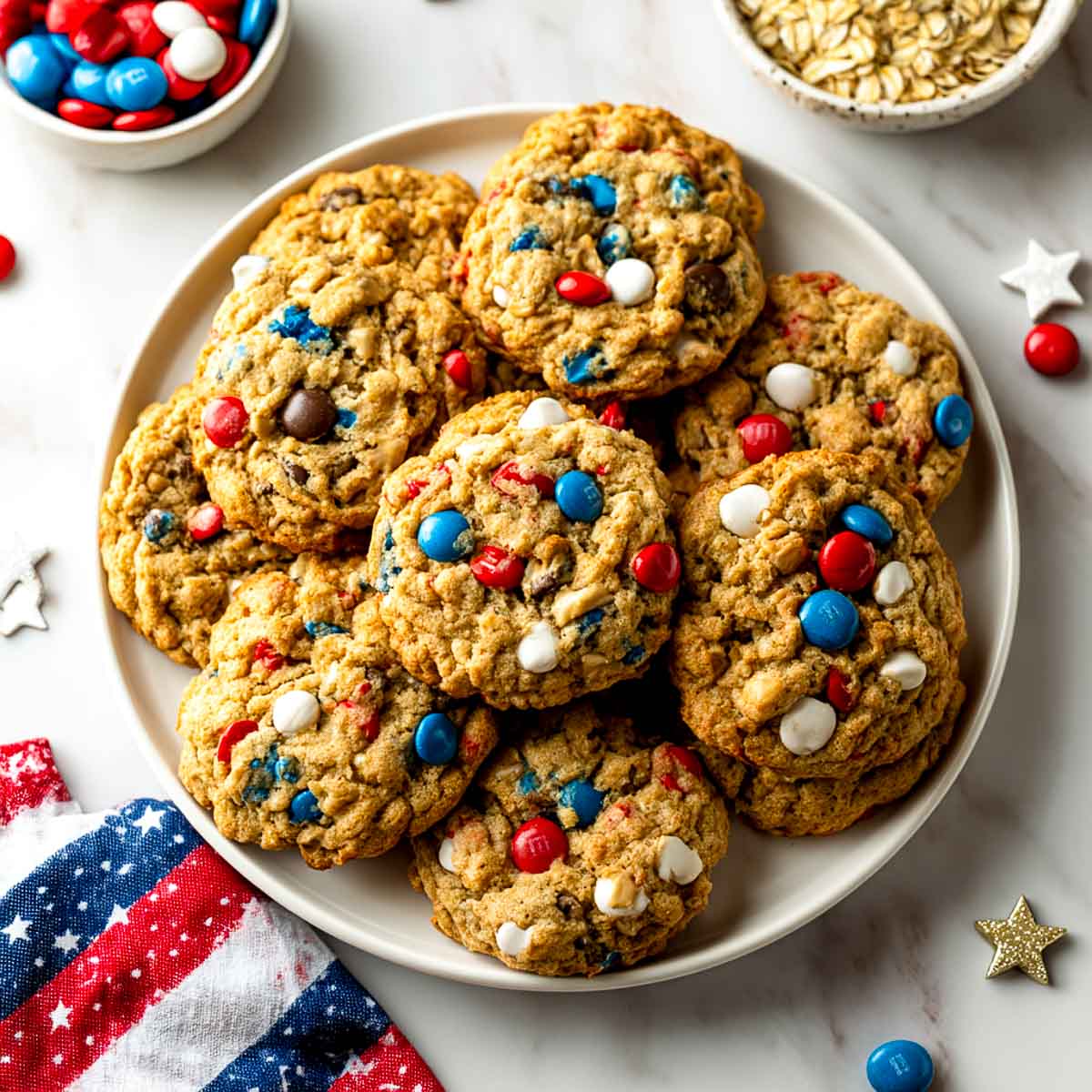 Top-down view of chunky oat cookies with red, white, and blue candies.