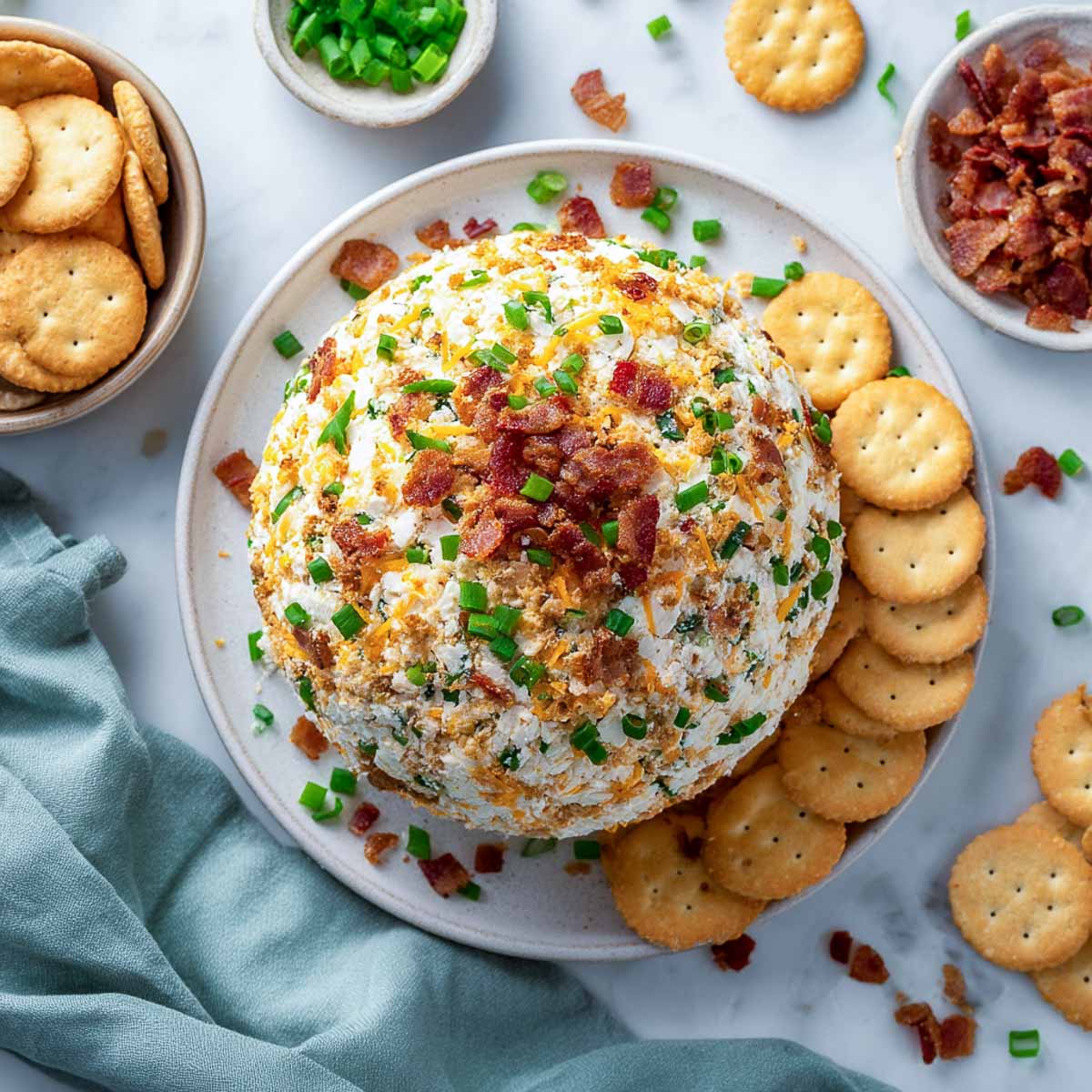 Million dollar cheese ball topped with bacon, cheddar, and green onions, served with crackers.
