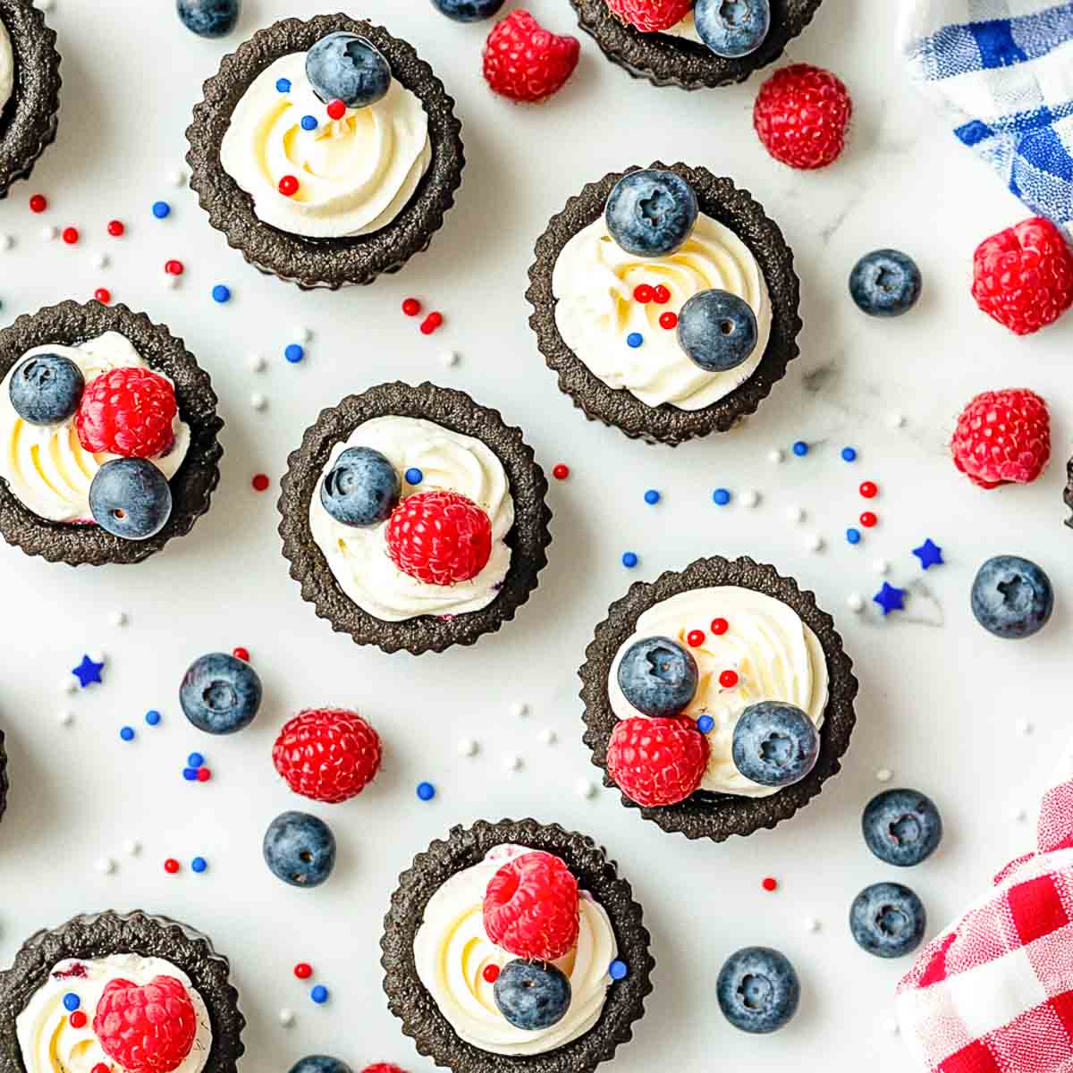 Mini Oreo pies with whipped cream, blueberries, raspberries, and patriotic sprinkles.