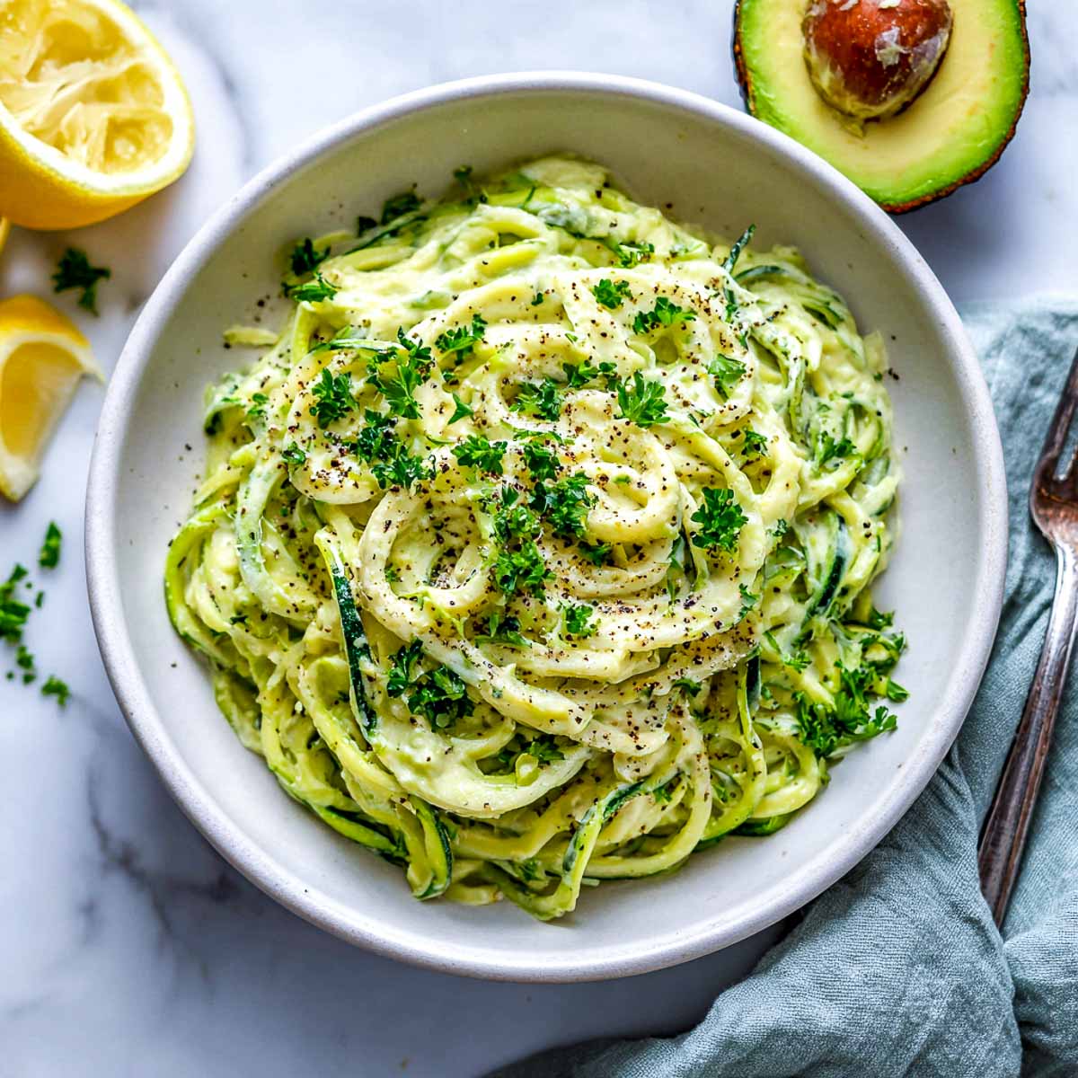 Zucchini noodles tossed in creamy avocado Alfredo sauce with parsley and lemon.