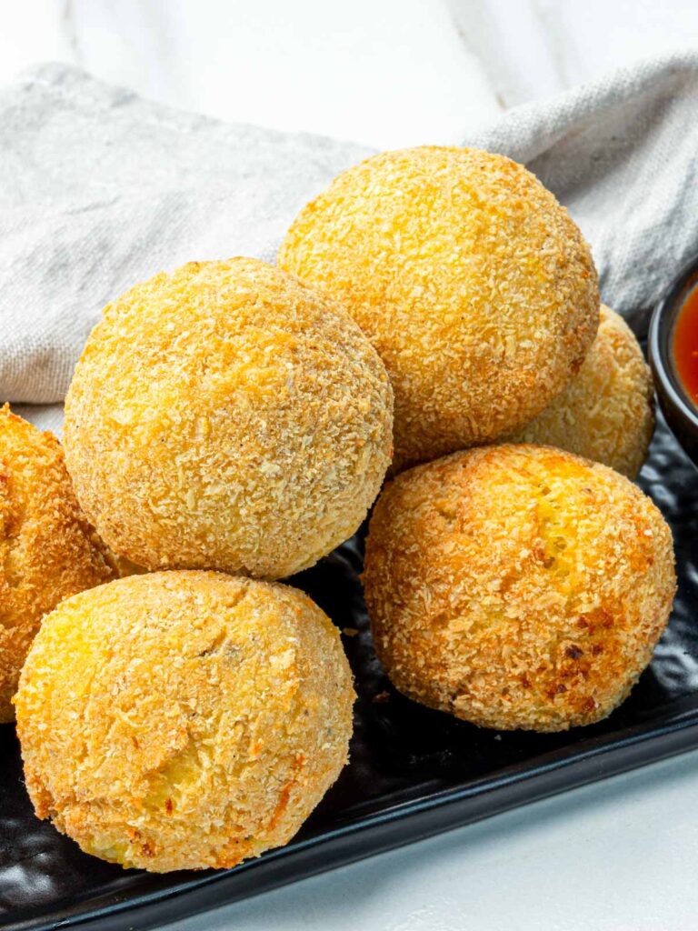 Close-up of crunchy potato cheese croquettes showing their crisp panko coating.