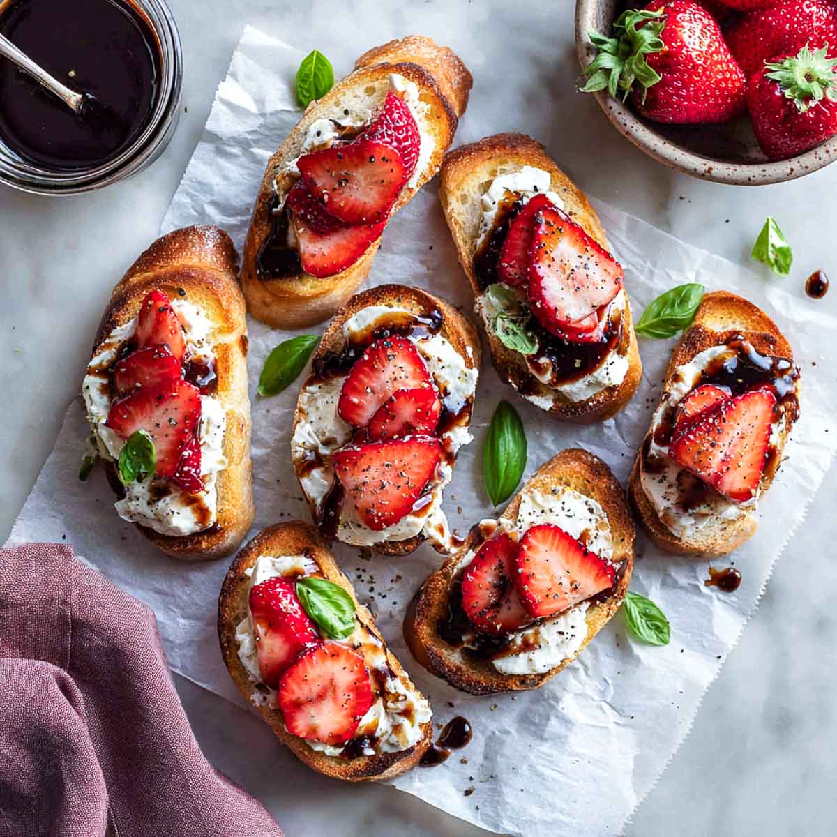 Toasted crostini topped with goat cheese, strawberries, and balsamic glaze.