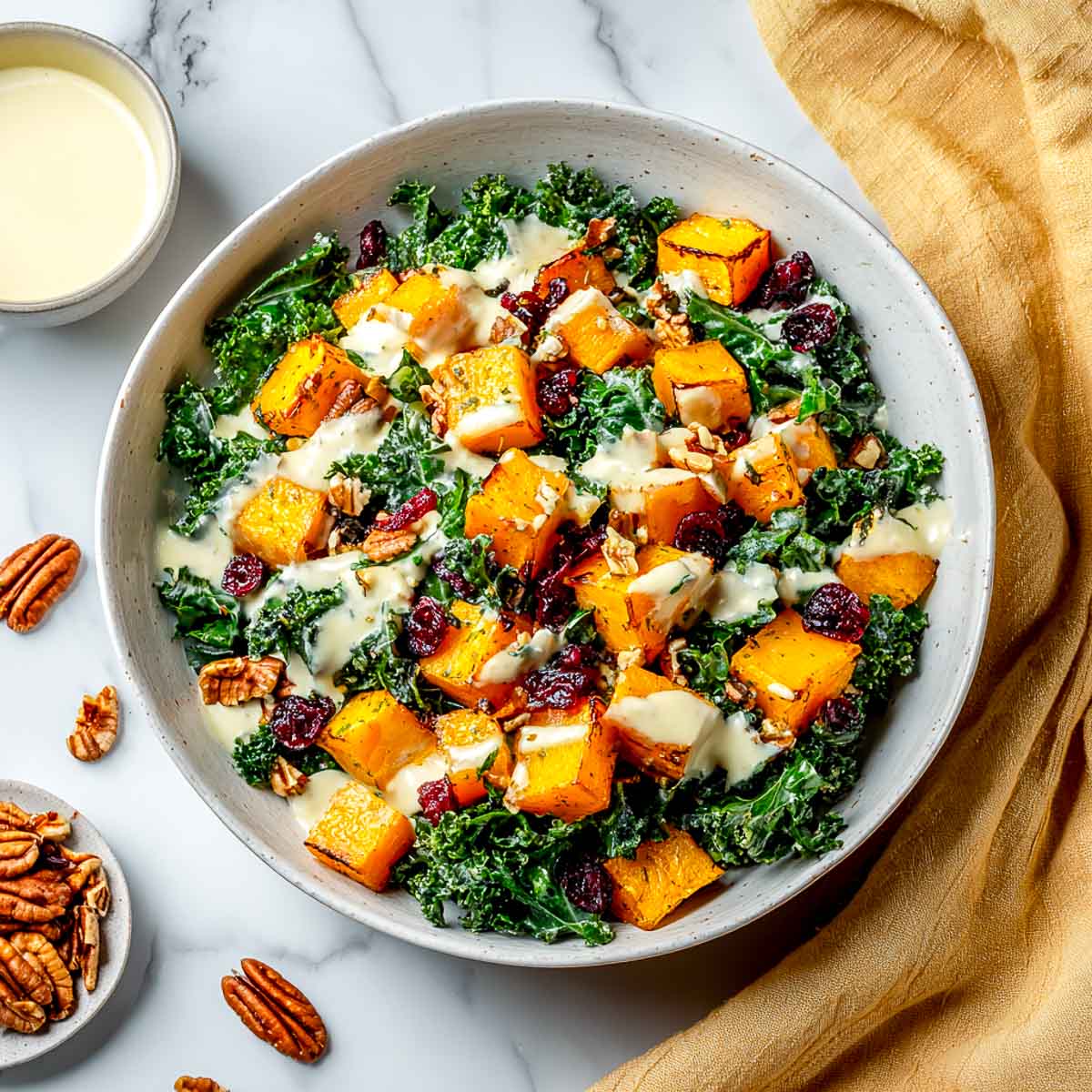 Butternut squash and kale salad with cranberries, pecans, and garlic dressing.