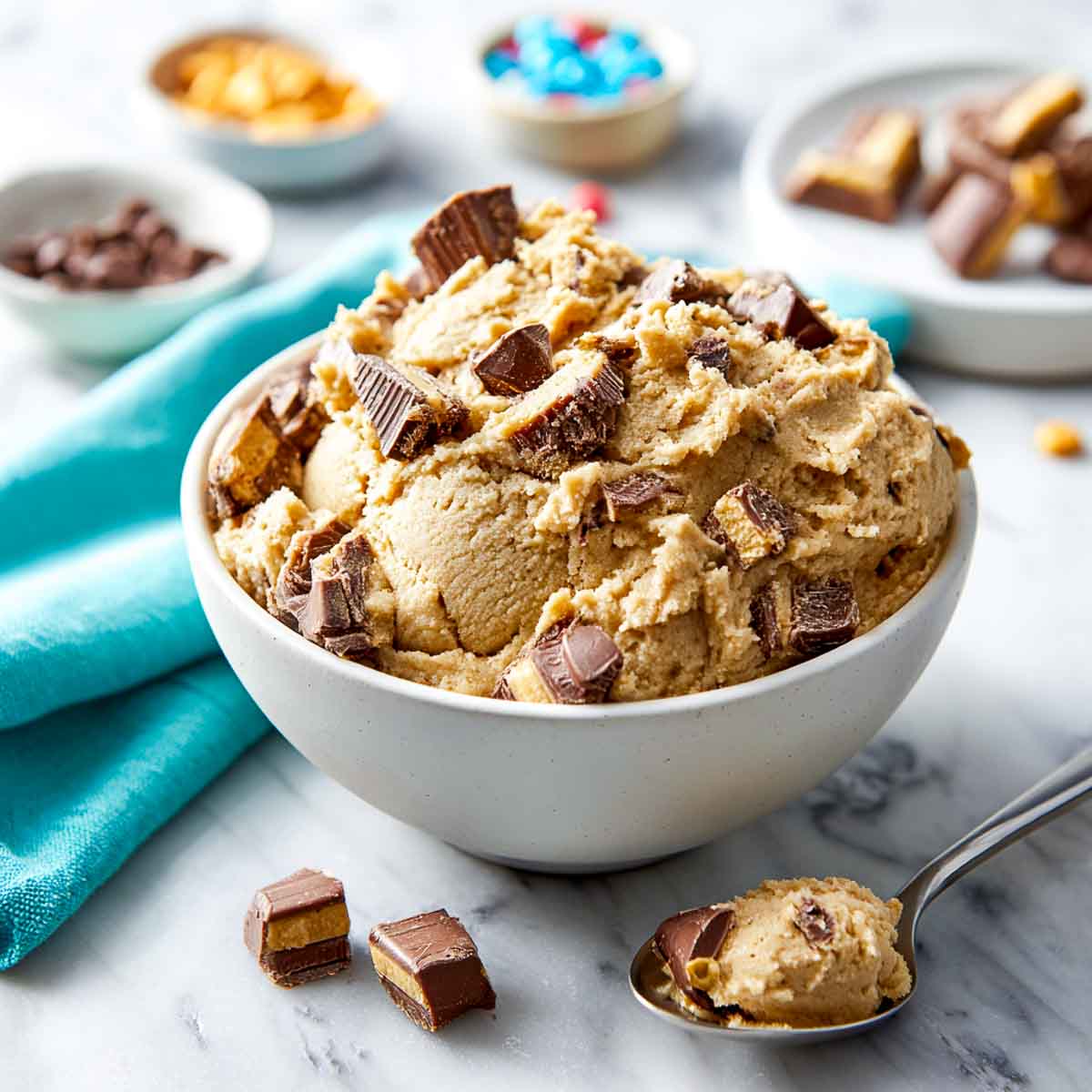 Edible cookie dough with chopped Halloween candy in a bowl.