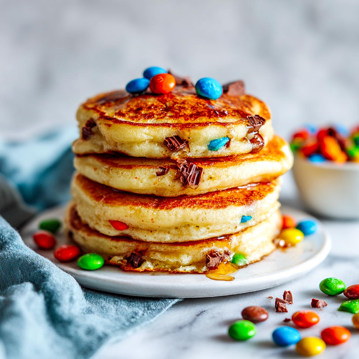 Stack of pancakes with colorful Halloween candy pieces inside.