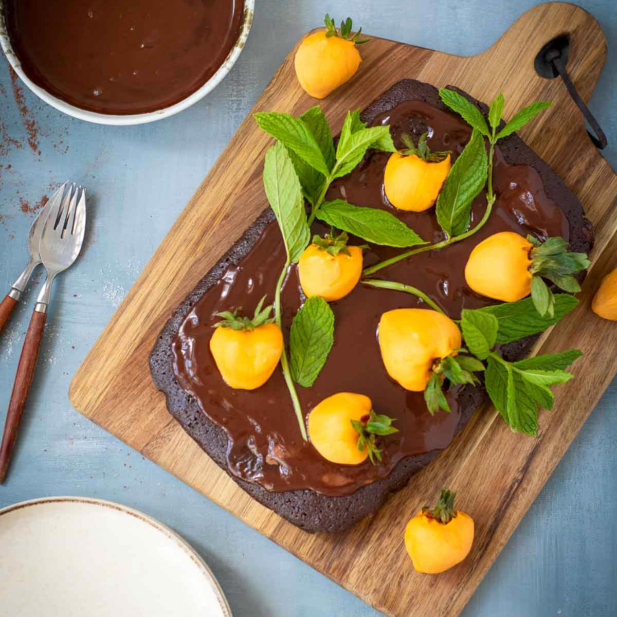 Finished chocolate brownie cake decorated with orange-dipped strawberry