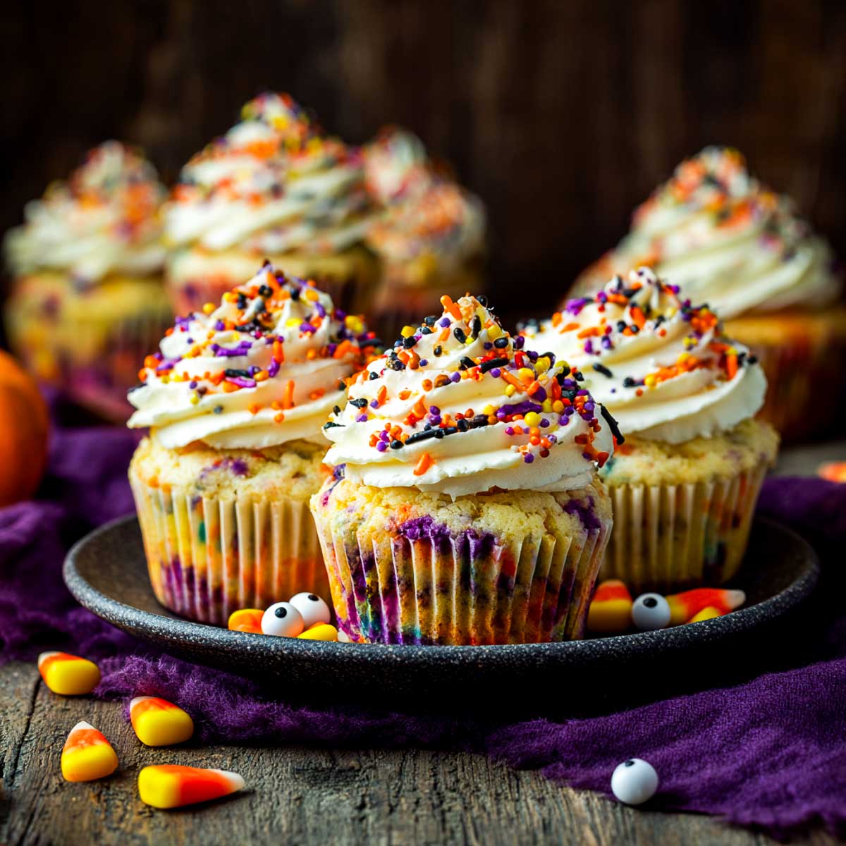 Halloween funfetti cupcakes with sprinkles baked inside and frosting swirls on top.